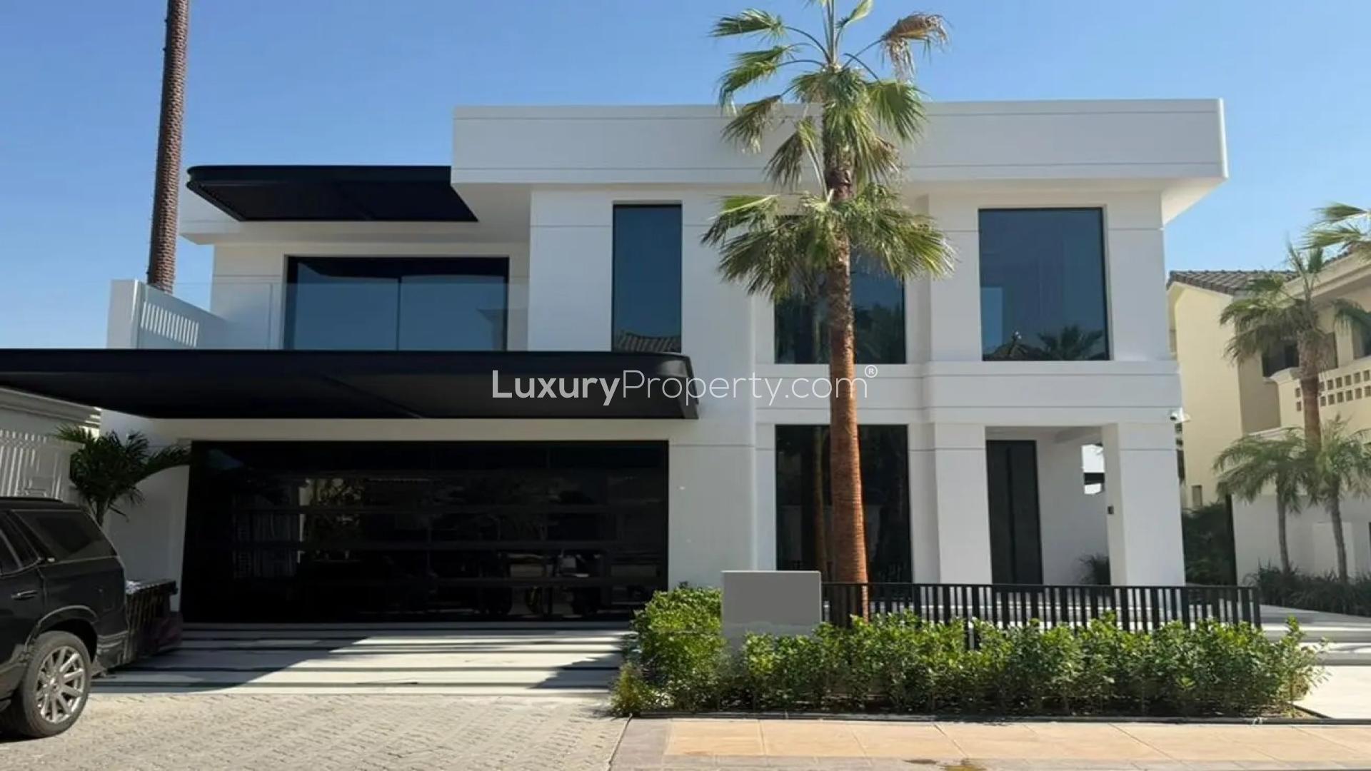 Luxurious villa living room with modern decor, overlooking Palm Jumeirah waterfront