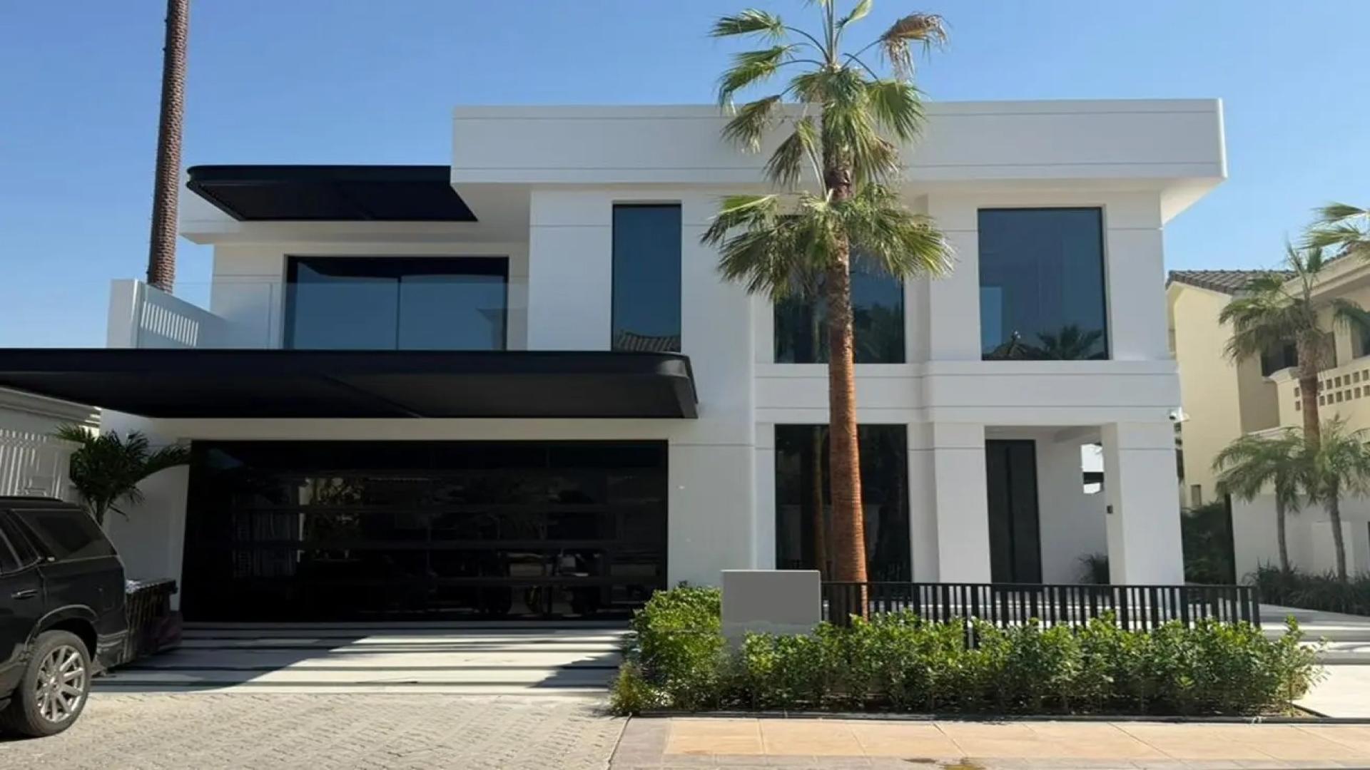 Luxurious villa living room with modern decor, overlooking Palm Jumeirah waterfront