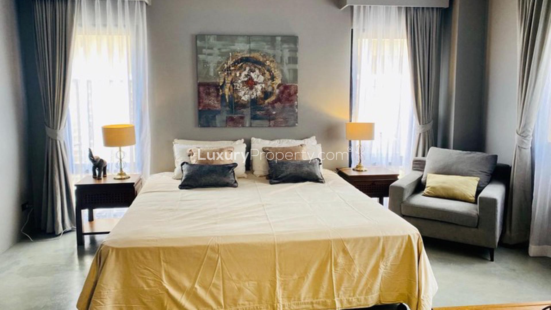 Luxurious bedroom in Phuket villa for sale, featuring elegant decor and natural lighting