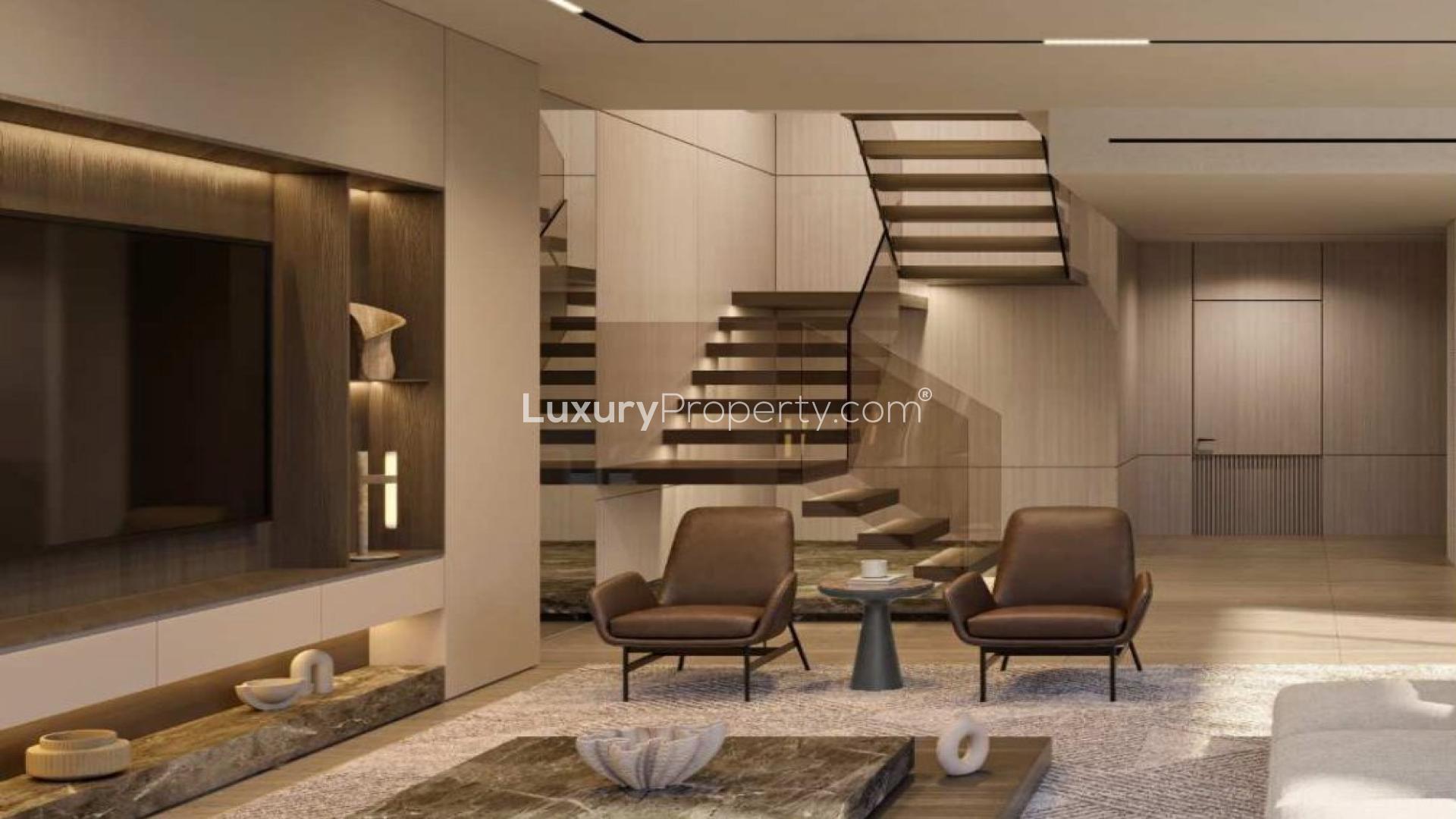 Modern living room in Jumeirah Golf Estates villa, featuring elegant decor and staircase