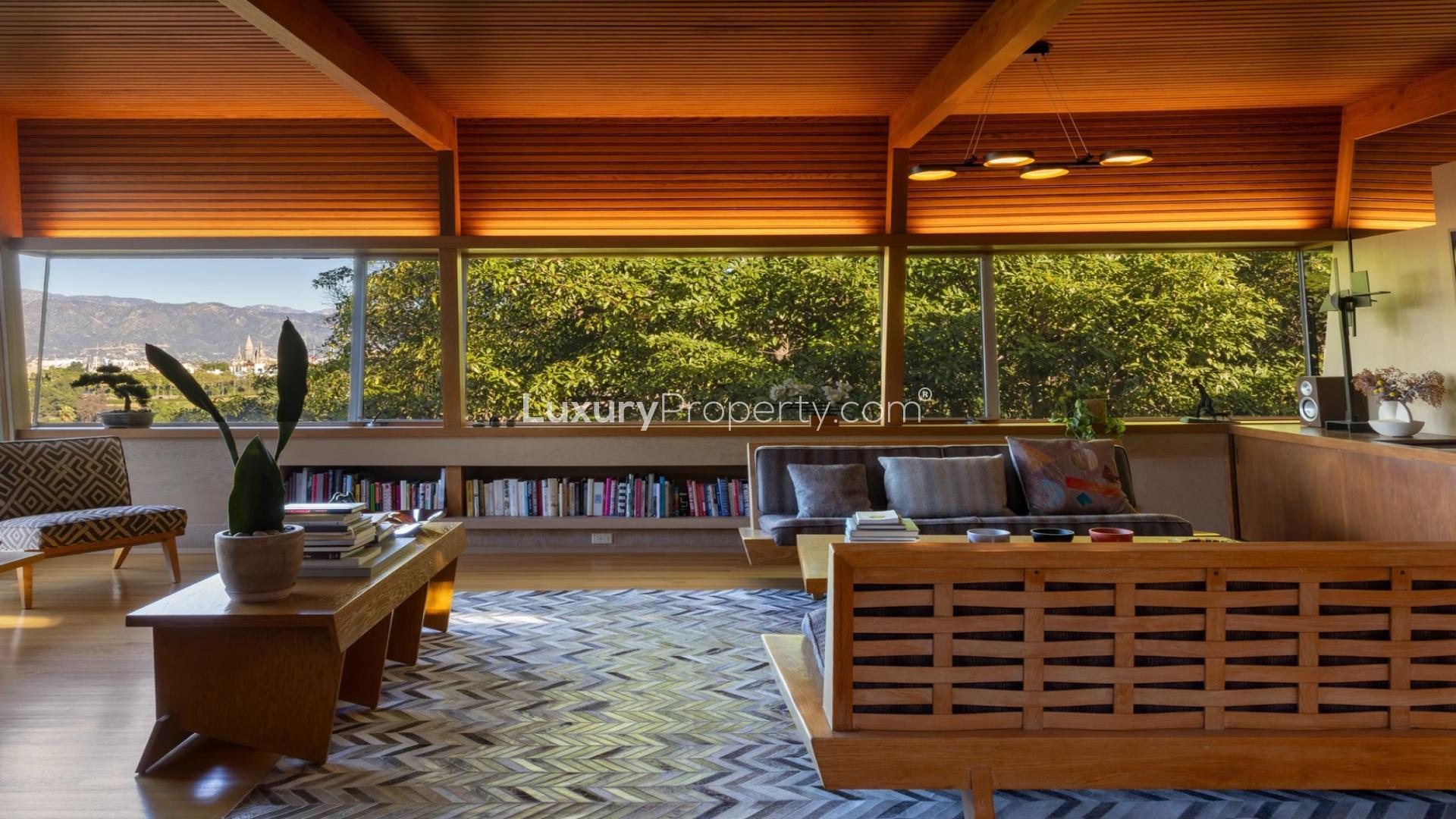 Luxurious dining area with fireplace and city views in Hollywood Hills villa for sale