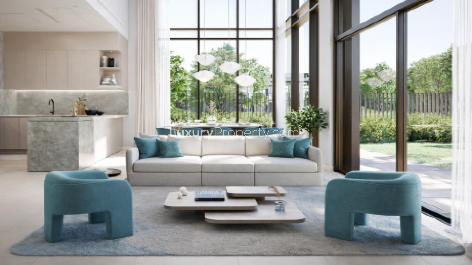 Luxurious living room in La Tilia villa, Dubailand with modern decor and garden view