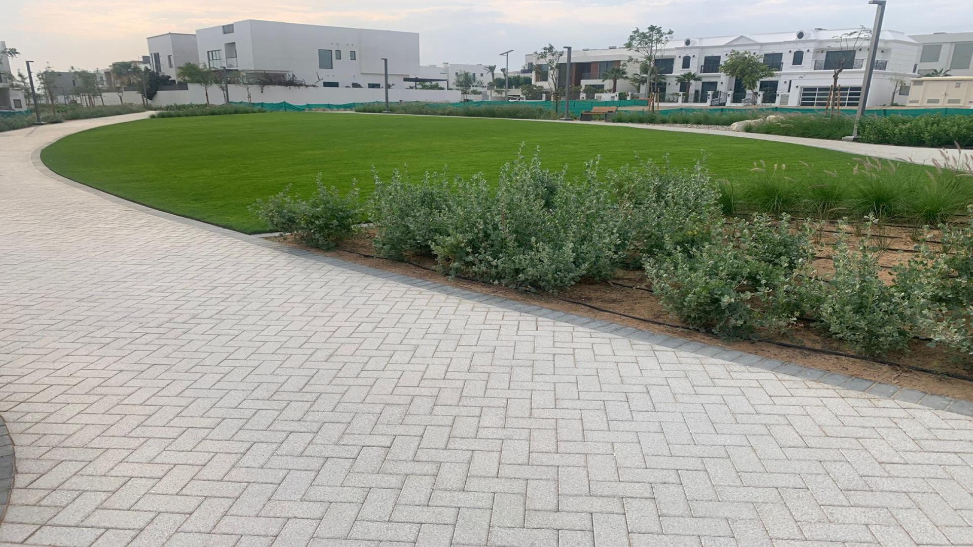 Modern living room in Al Furjan West villa for sale, featuring elegant decor and natural light