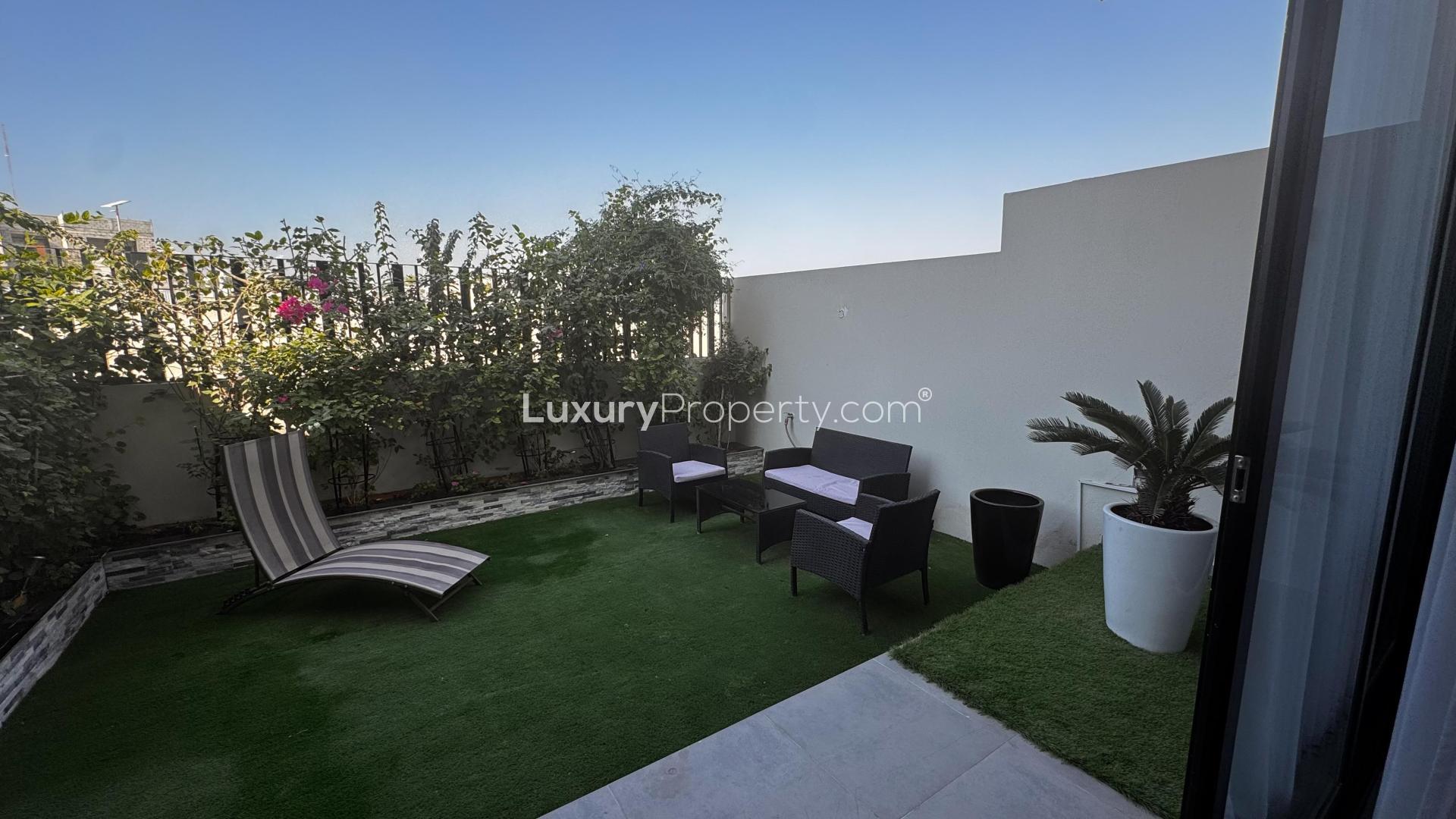 Modern open-plan kitchen and living area in Al Furjan West villa for sale