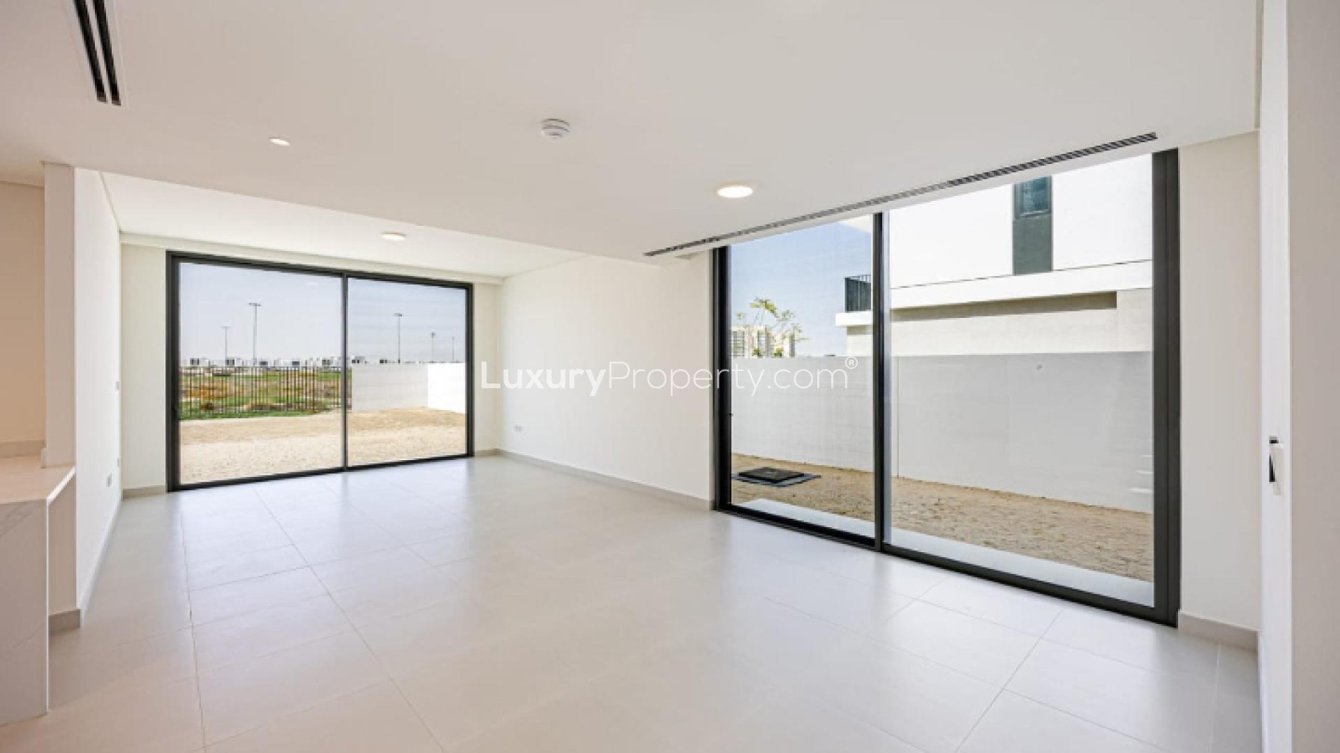 "Fairway Villa golf course view in Dubai South, luxury living, single row property.",Spacious living room with large windows in Fairway Villa, Dubai South