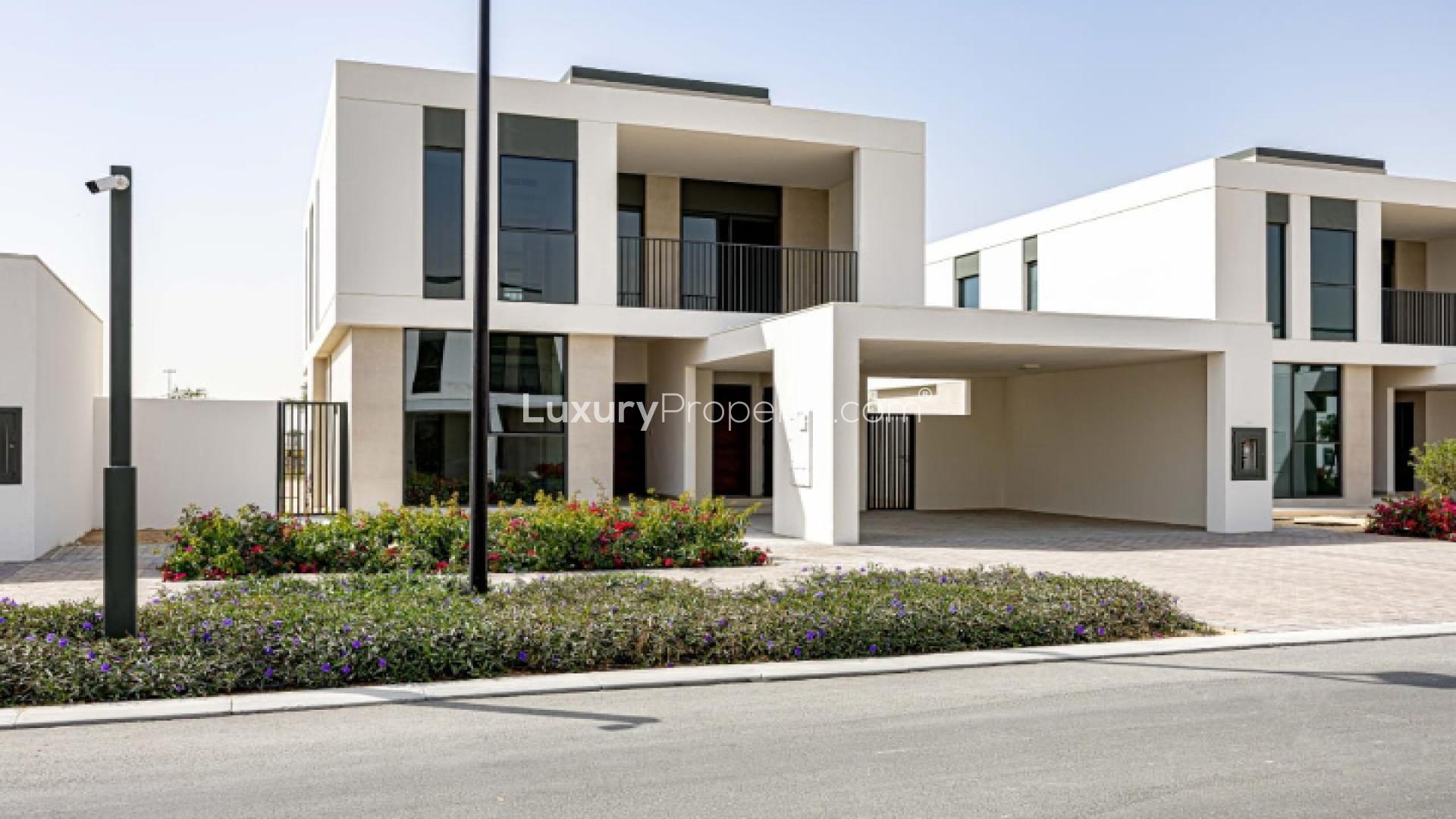 Modern open-plan living area in Fairway Villa, Dubai South, with large windows and staircase