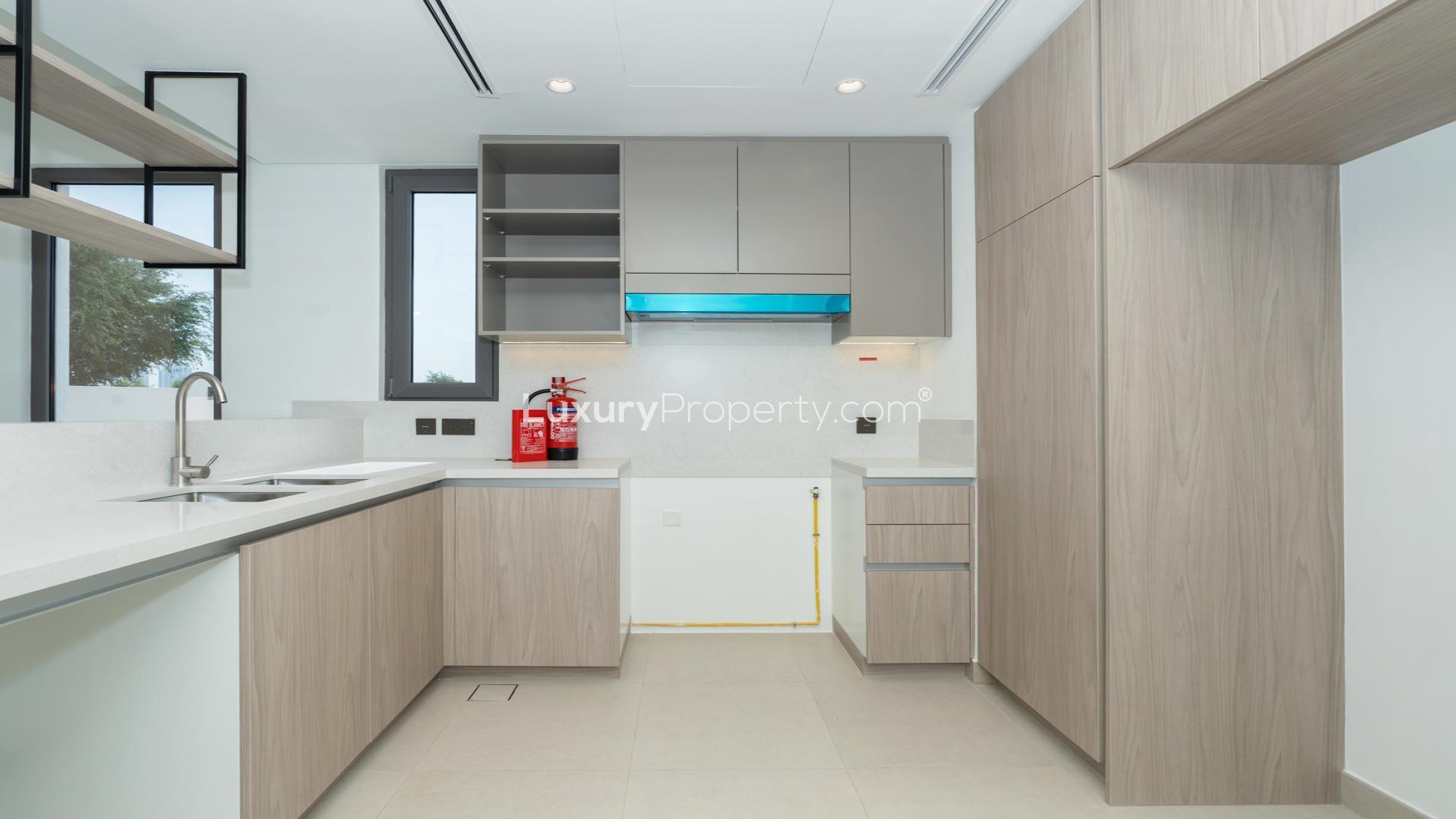 Modern open-plan living area in Tilal Al Ghaf villa for sale, Aura 3 community