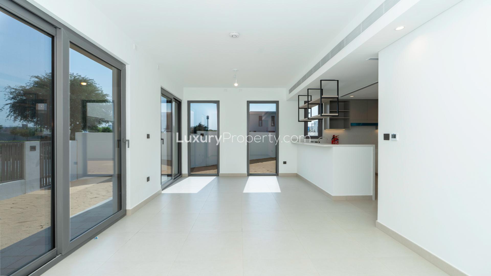 Modern kitchen and living area in Tilal Al Ghaf Aura 3 villa for sale