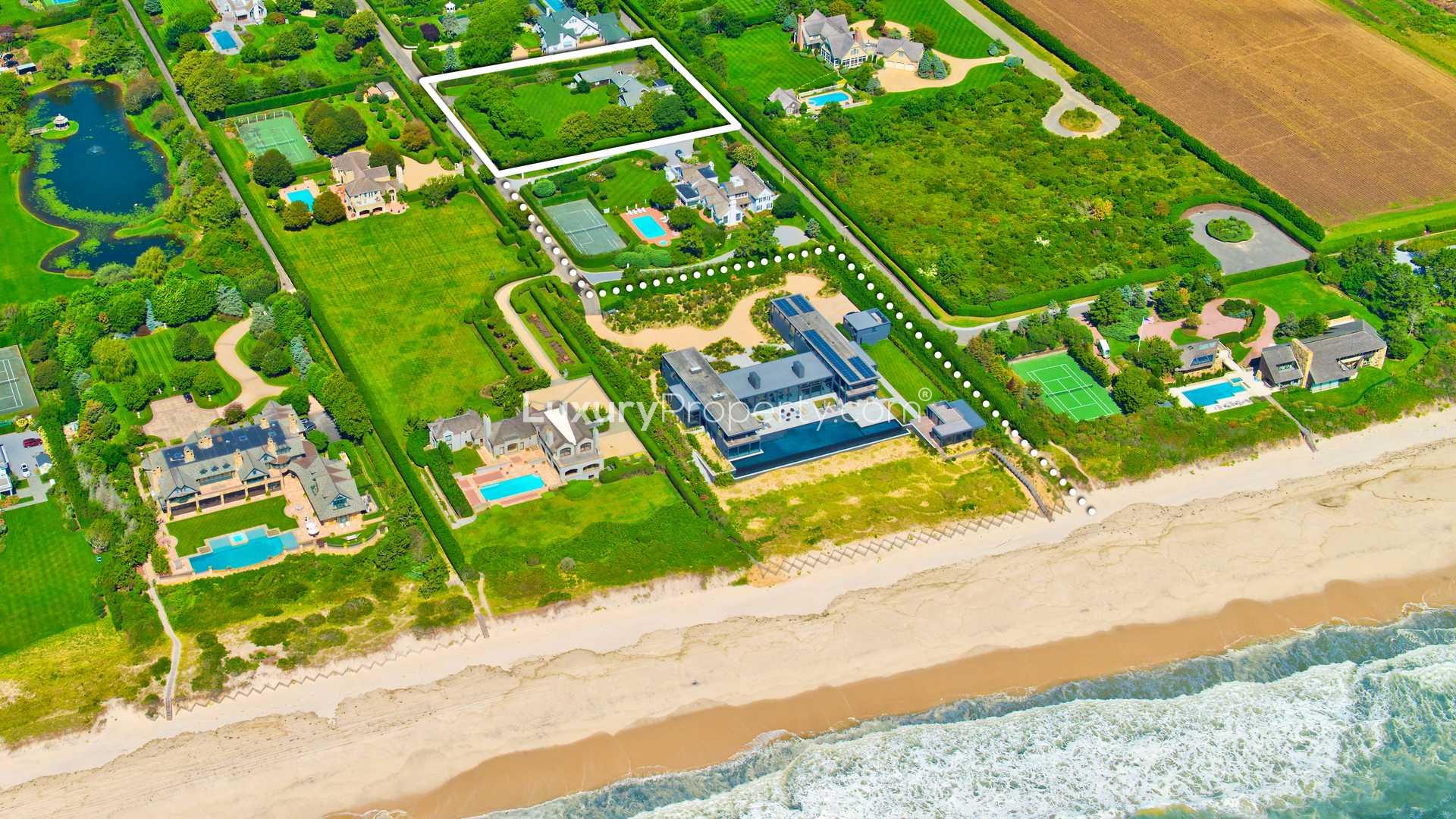 Aerial view of beachfront villa, lush gardens, and pool in Southampton, NY Hamptons