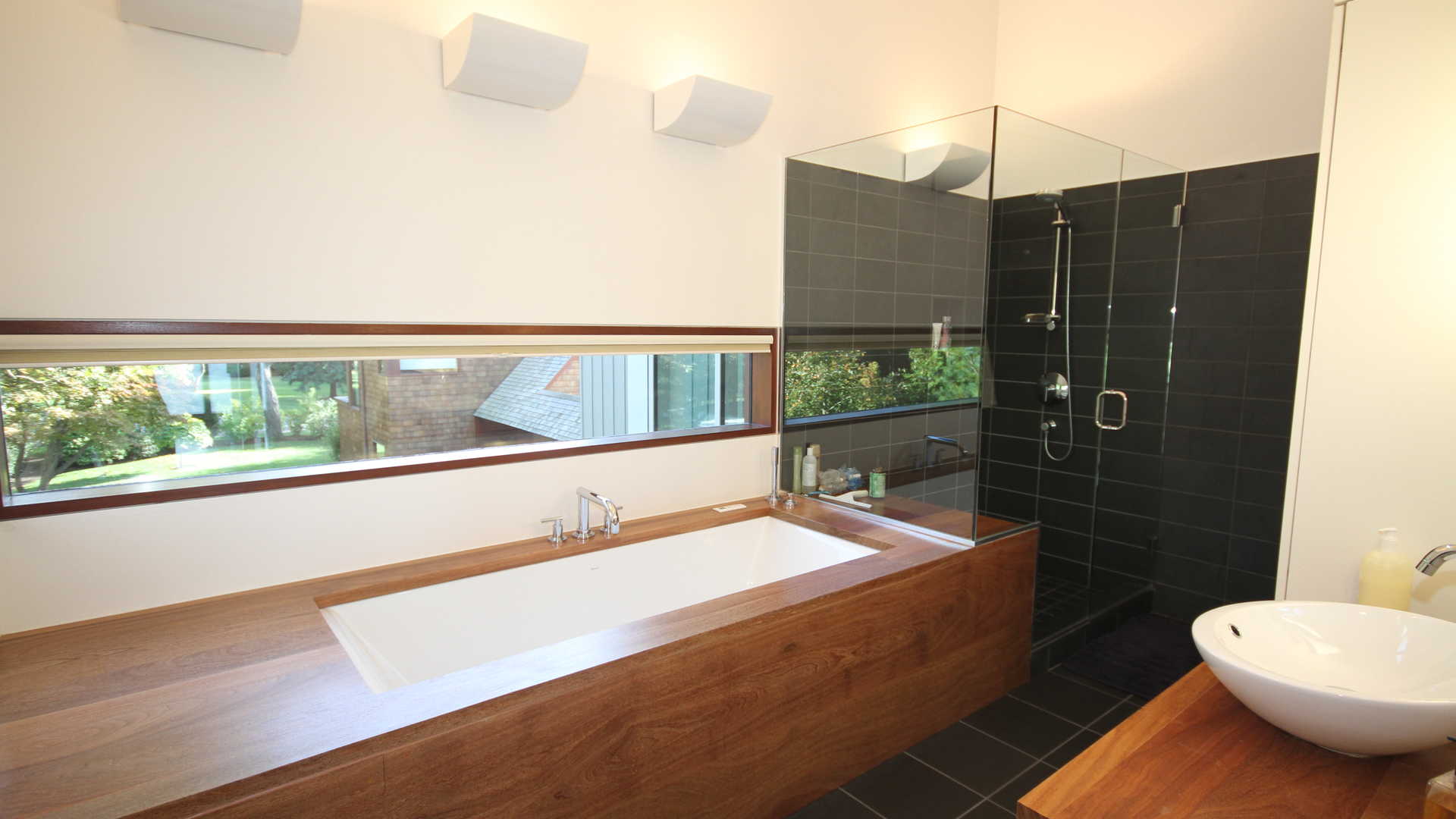Modern bathroom with wooden accents in Hamptons villa at 43 Noyac Bay Avenue