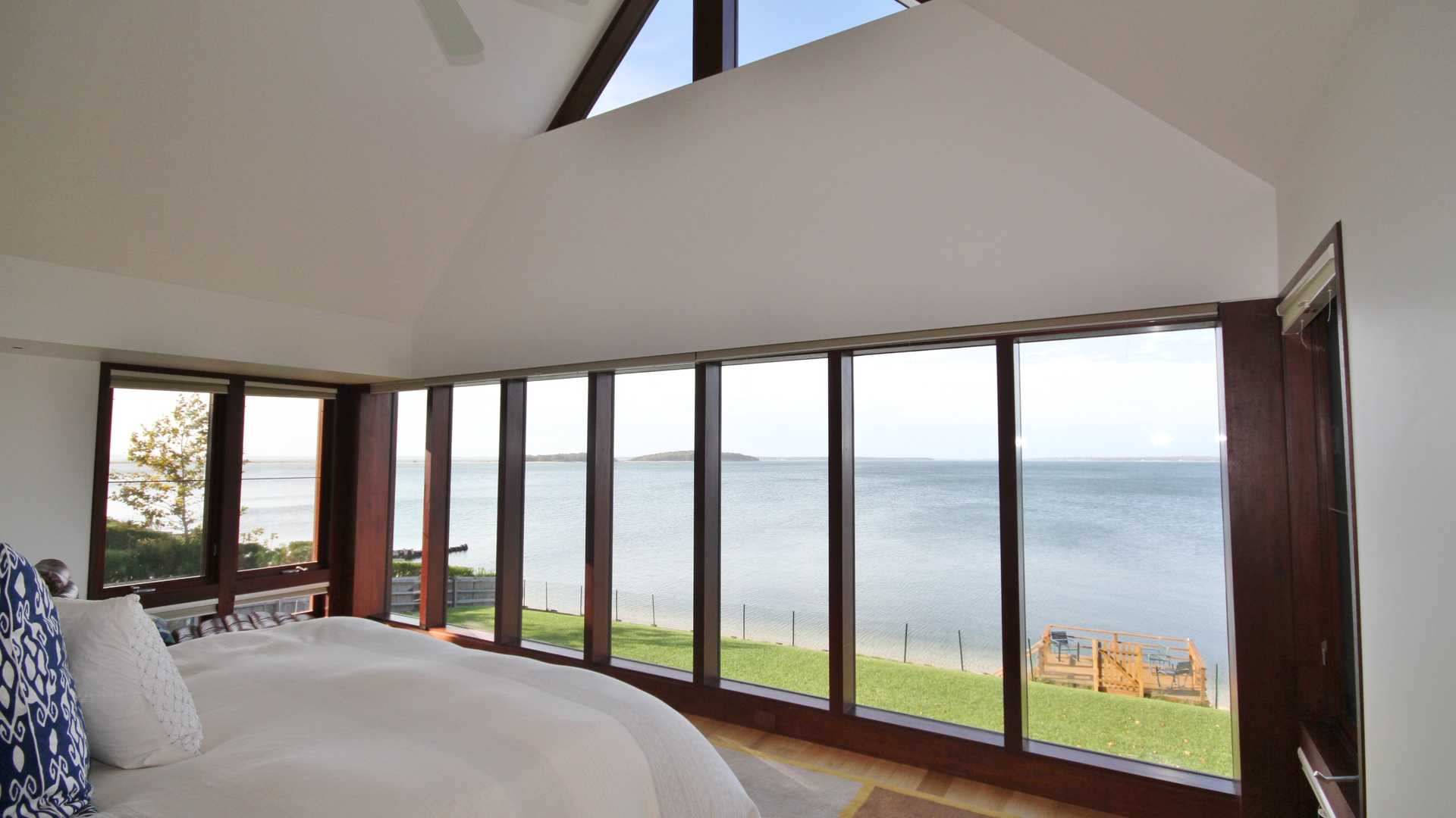 Luxurious Hamptons villa bedroom with stunning waterfront views at 43 Noyac Bay Avenue