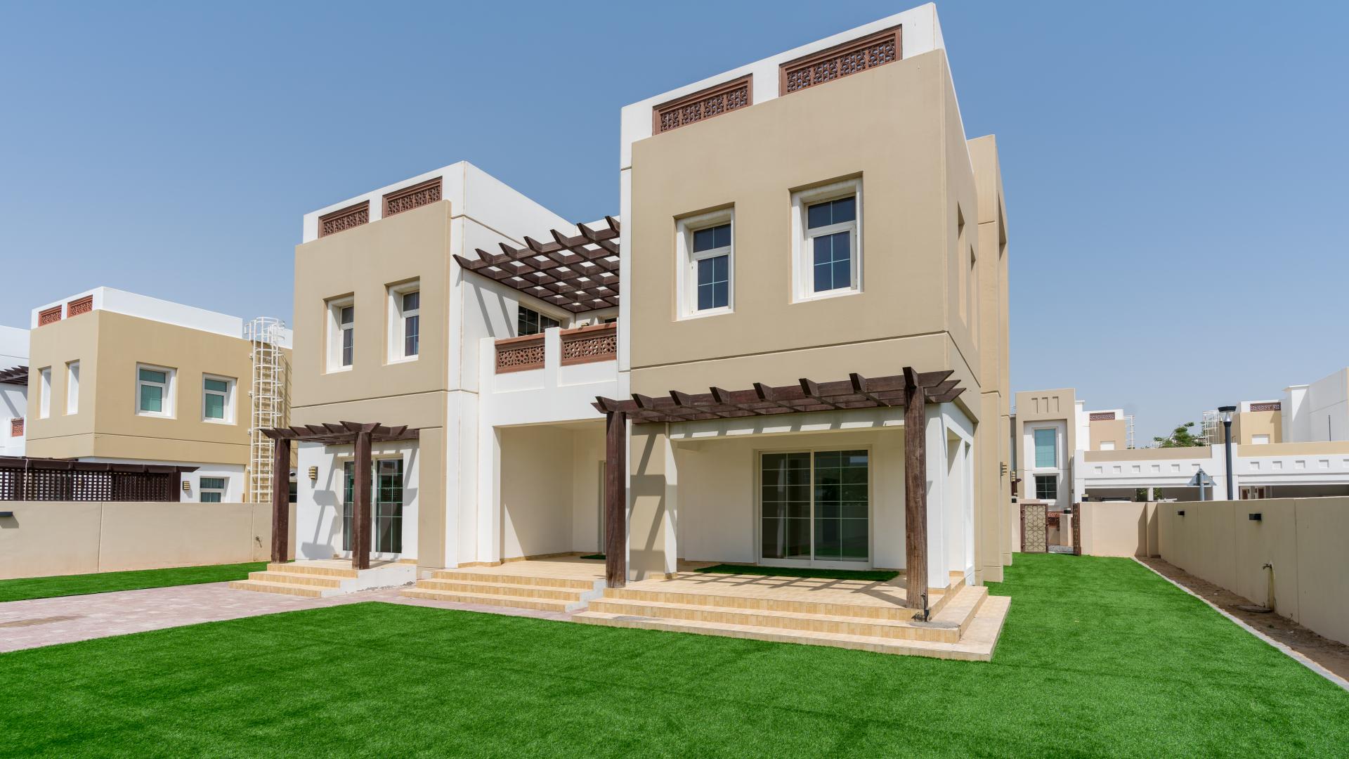 Spacious living room with large windows in Rahat villa, Mudon community, for sale