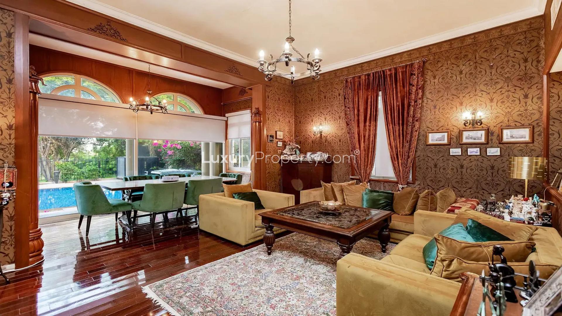 Luxurious villa interior with elegant chandelier and tapestry in Jumeirah Islands, Cluster 32