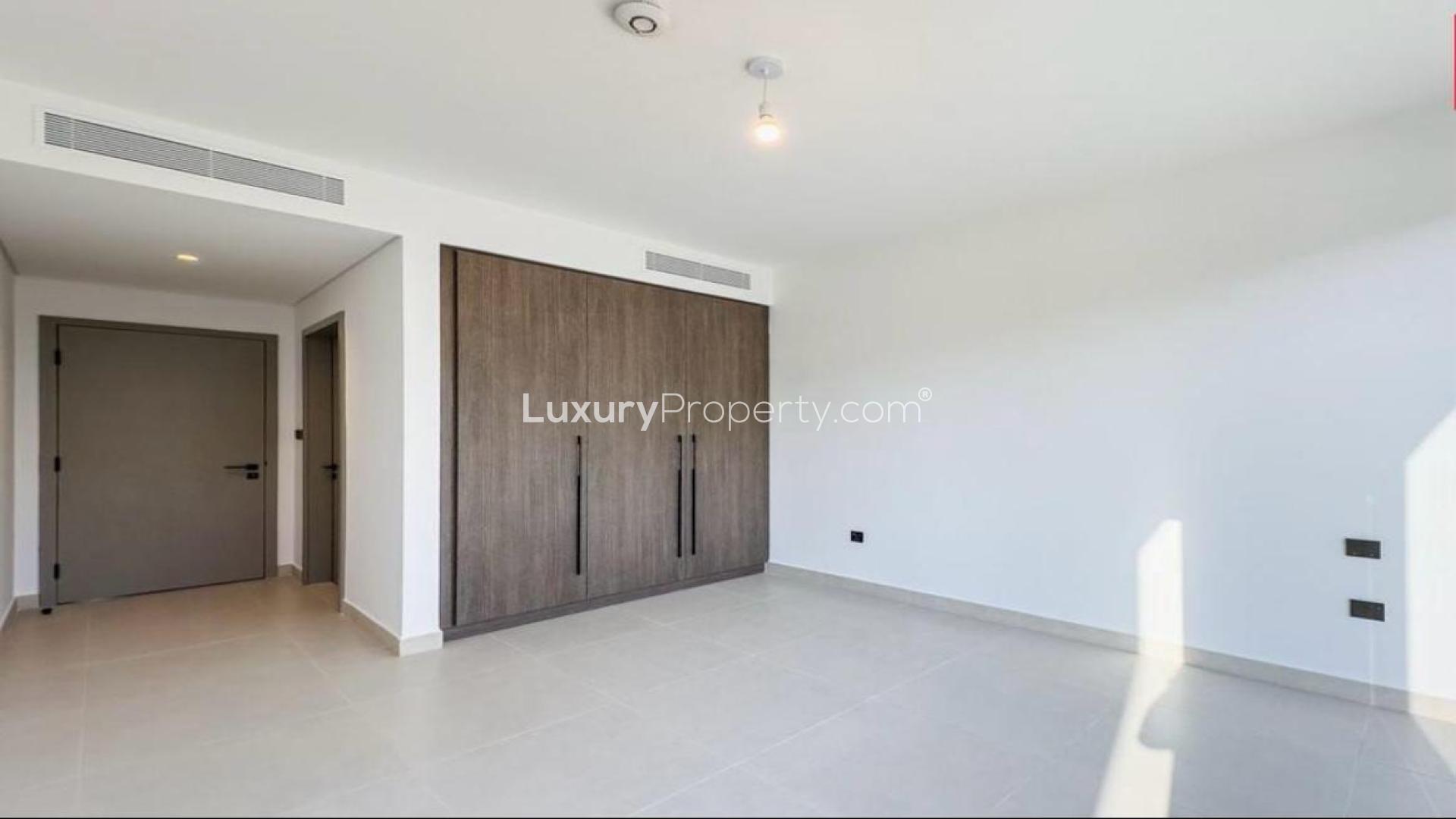 Modern open-plan kitchen and living area in 4-bedroom Aura Villa, Tilal Al Ghaf