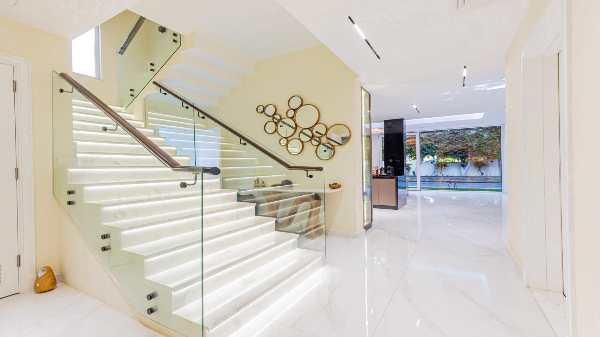 Luxurious villa entrance with modern staircase in Victory Heights, Dubai Sports City