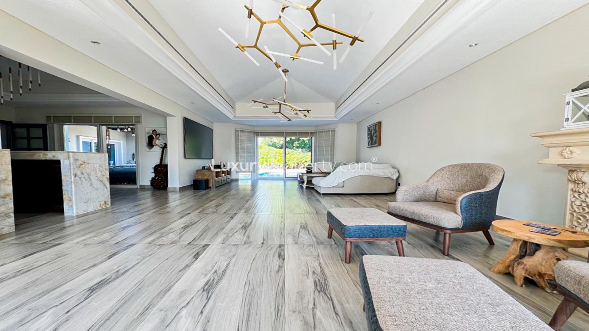 Spacious living room in fully upgraded villa, Green Community West, with modern decor and pool view