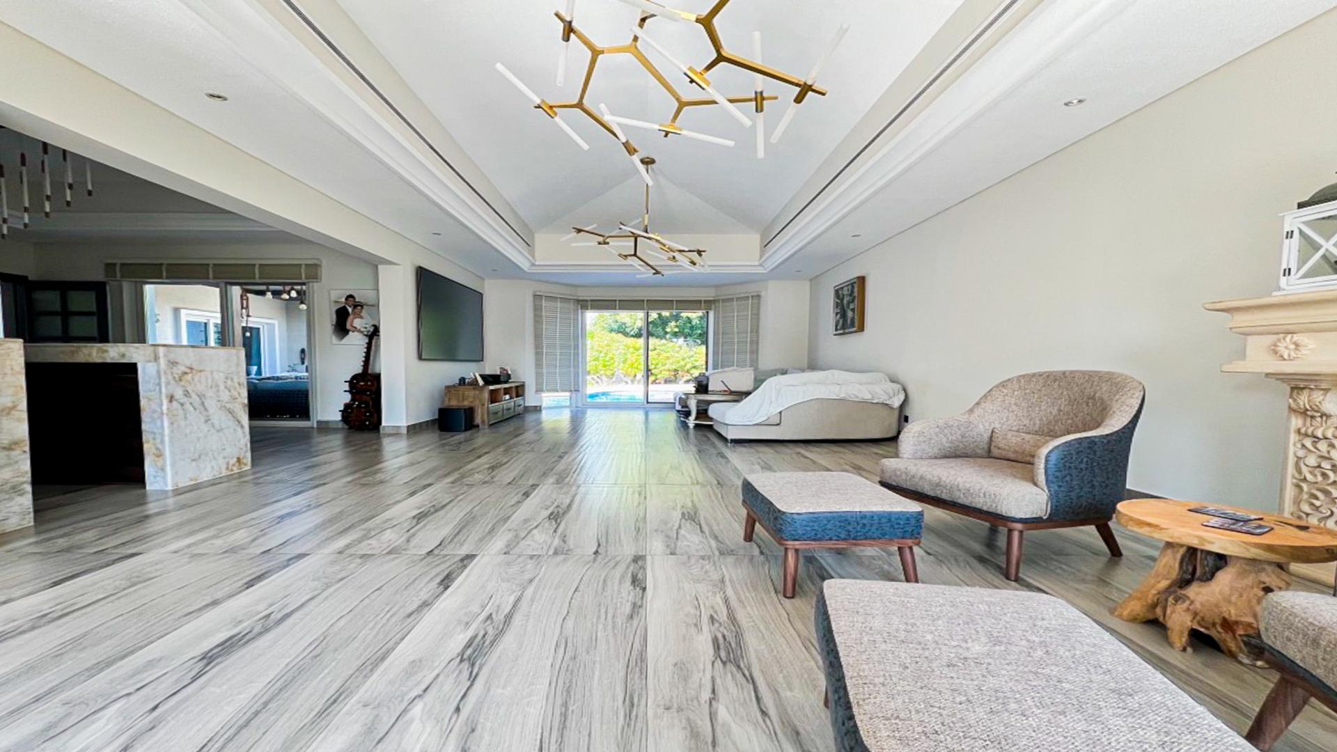 Spacious living room in fully upgraded villa, Green Community West, with modern decor and pool view