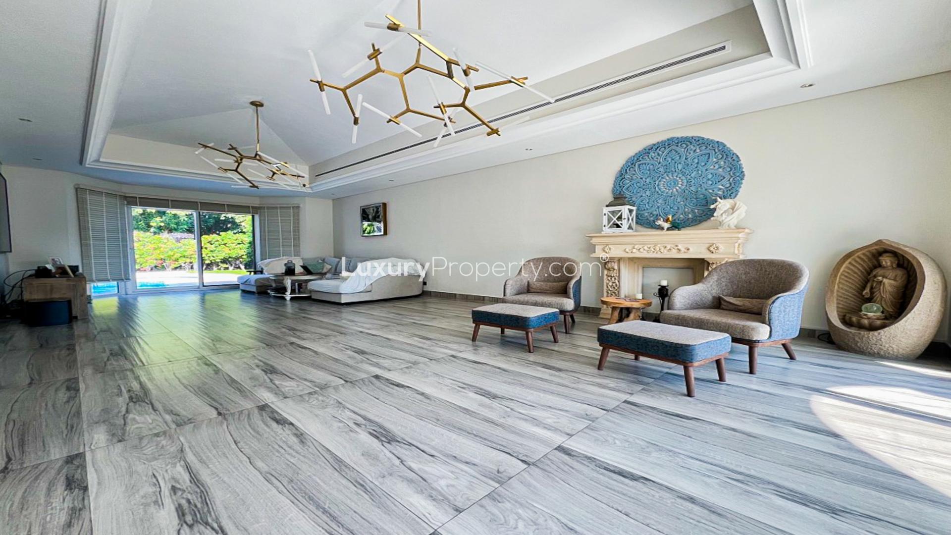 Luxurious villa living room with modern decor and pool view in Green Community West