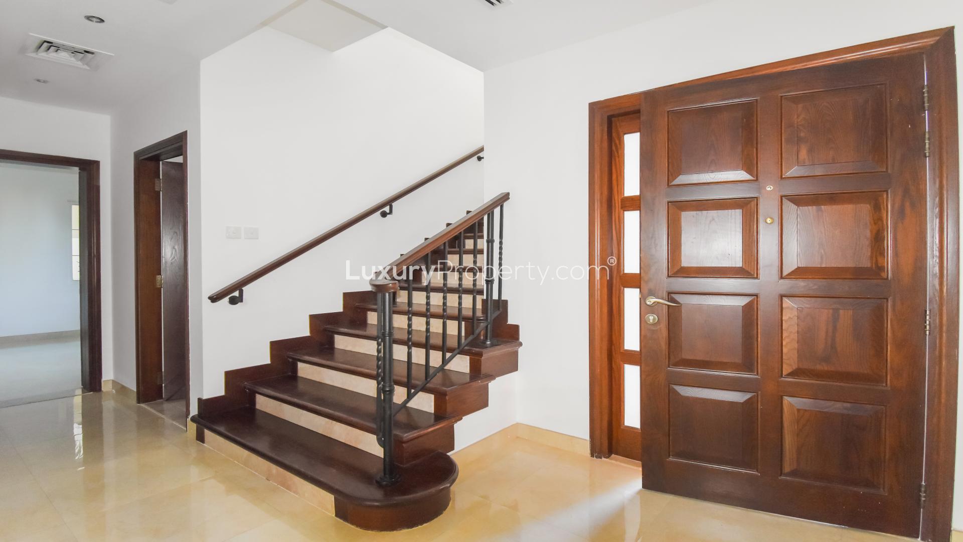 "Elegant staircase and wooden door in Alvorada 4-bedroom villa, Arabian Ranches for sale.",Bright living area in upgraded 4-bedroom villa, Alvorada, Arabian Ranches, for sale