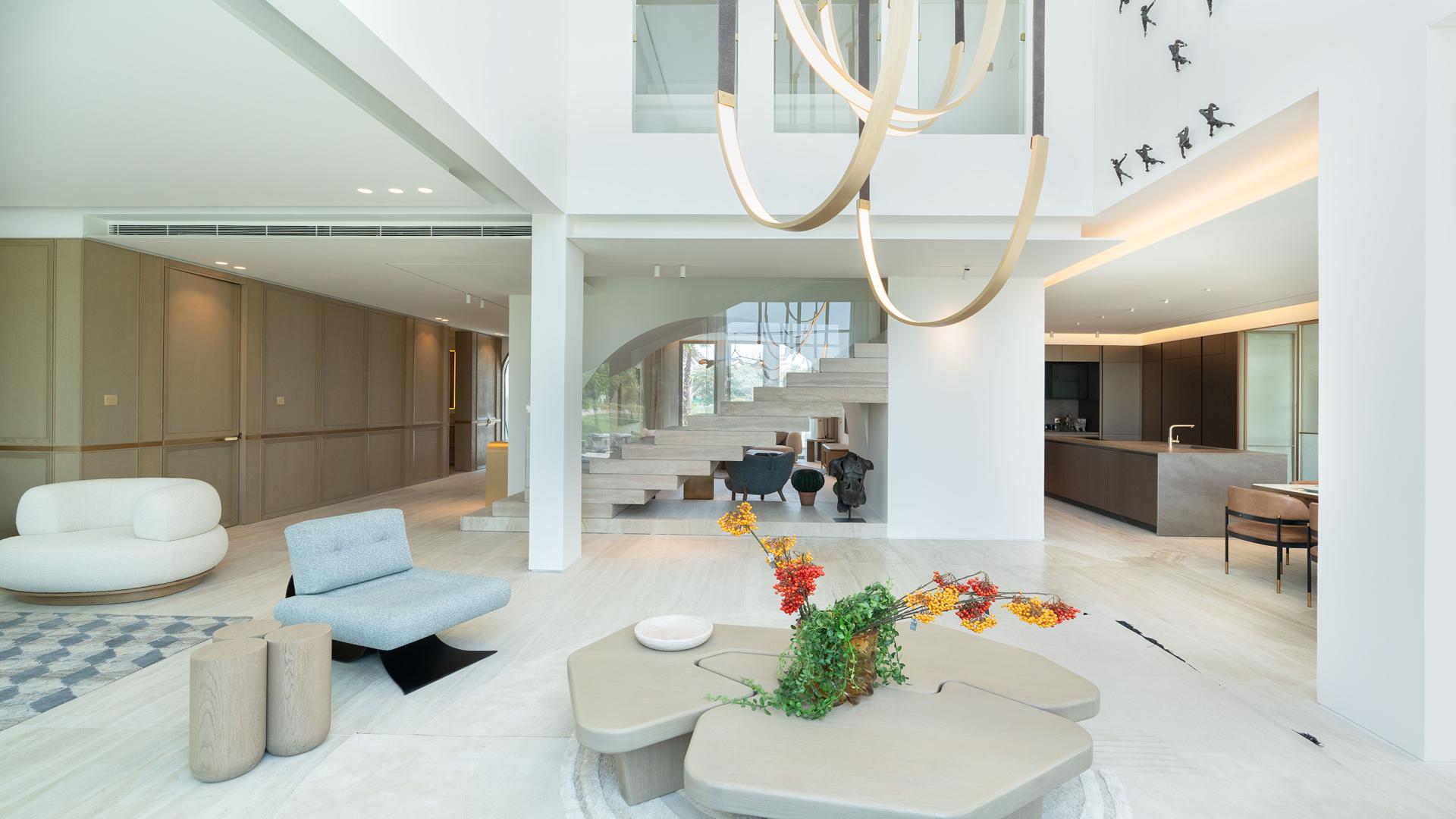 Luxurious villa interior with modern decor, large windows, and lake view in Jumeirah Islands