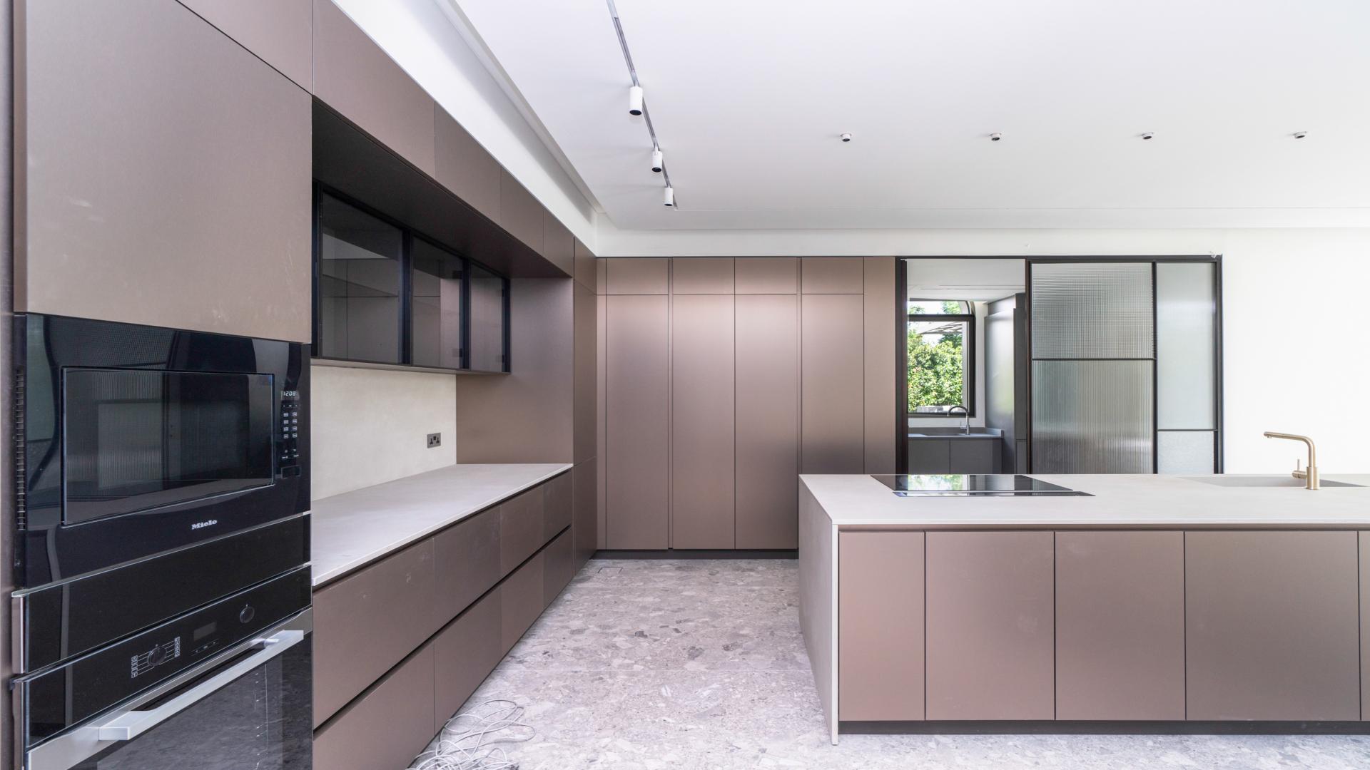 "Spacious villa interior with large windows and garden view in Jumeirah Islands.","Modern kitchen with sleek cabinetry in fully renovated Jumeirah Islands villa for rent.",Fully renovated villa interior with modern finishes, open layout, and natural light in Jumeirah Islands