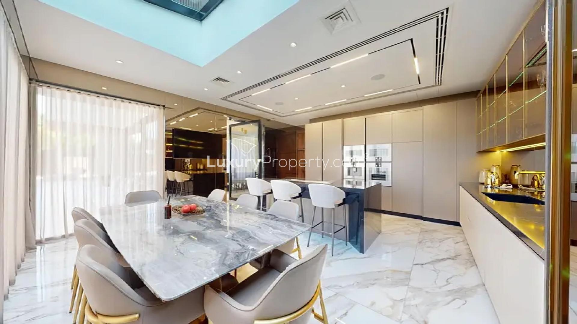 Modern kitchen in luxury Al Barari villa, featuring sleek countertops and spacious dining area