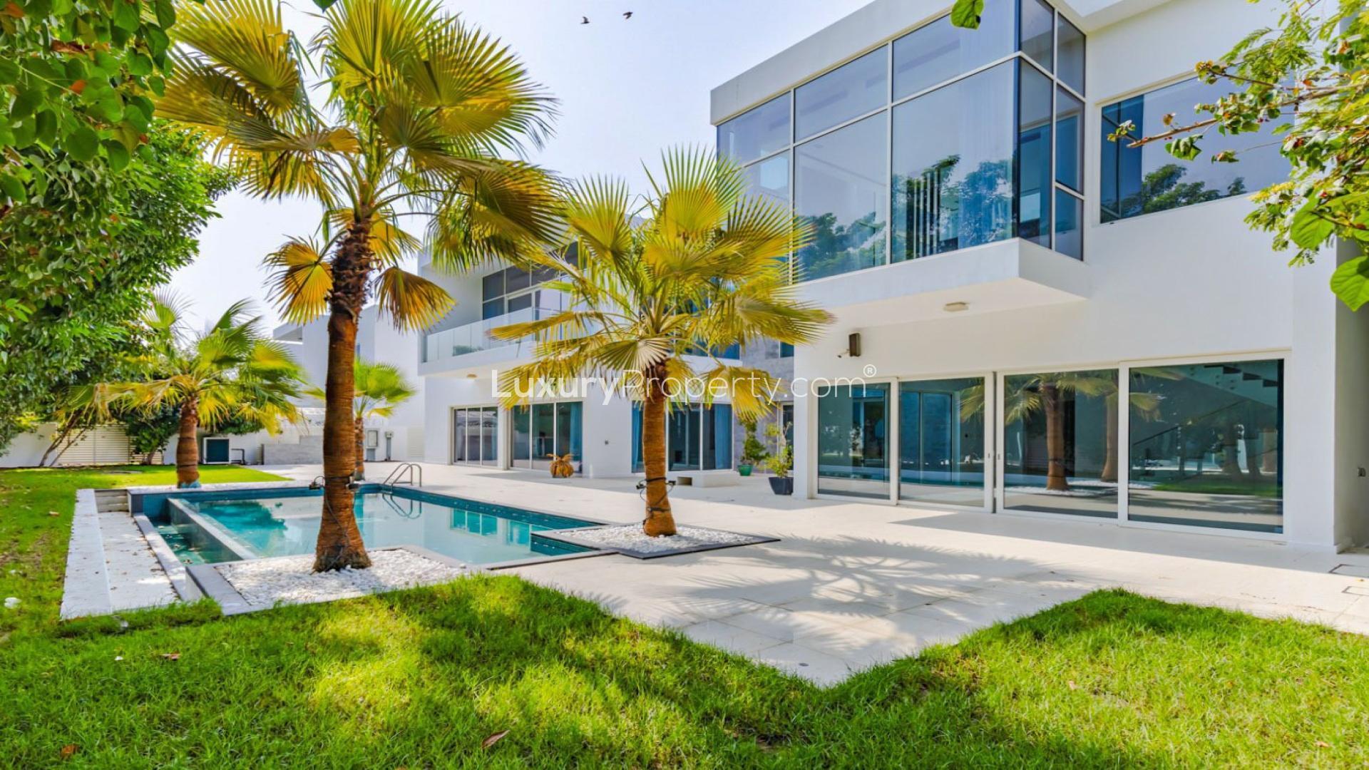 "Spacious patio and lush garden view of luxury villa in The Nest, Al Barari.",Luxury 4-bedroom villa with pool and garden at The Nest, Al Barari for sale