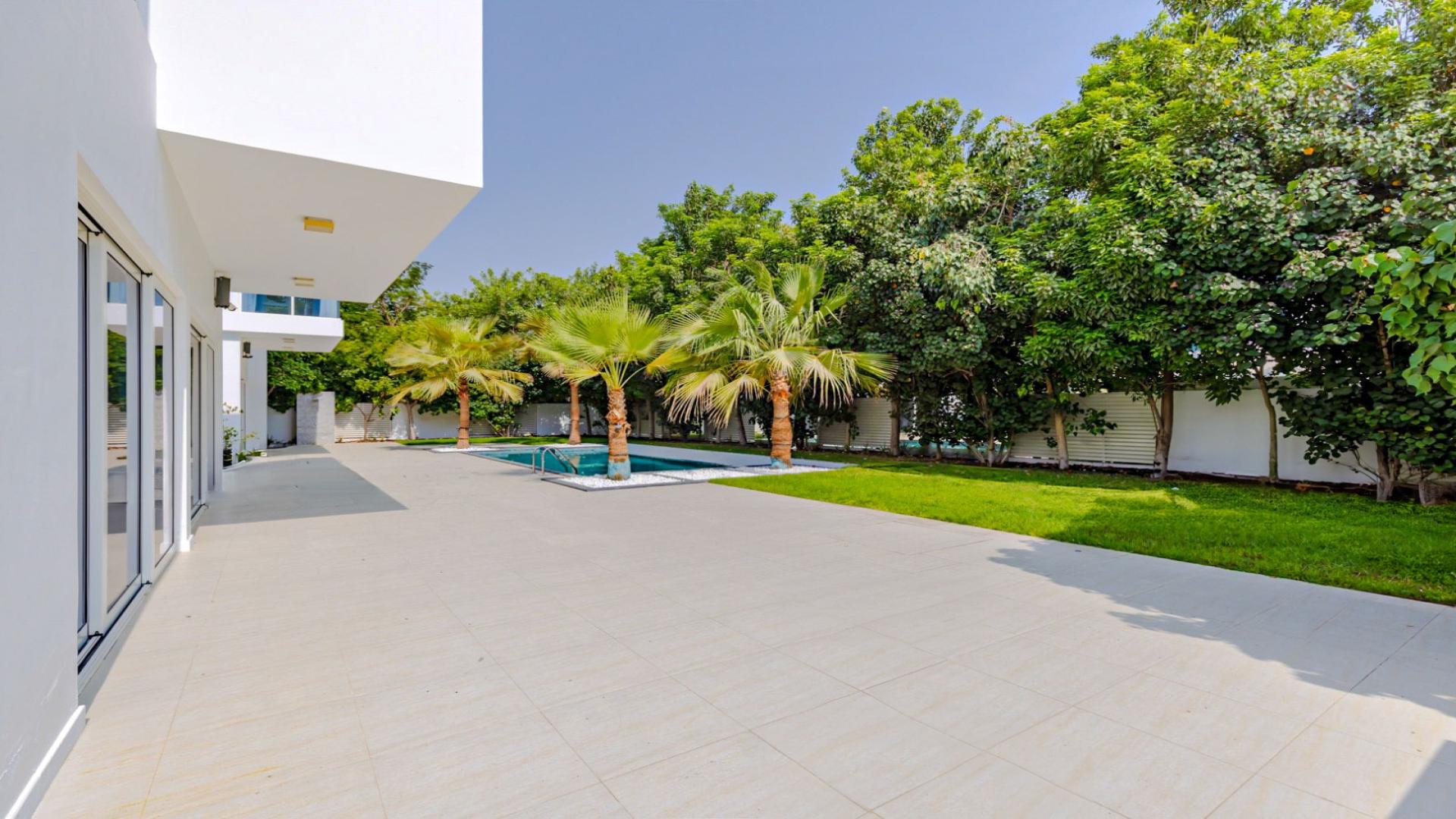Luxury villa courtyard at The Nest, Al Barari, featuring modern design and large windows