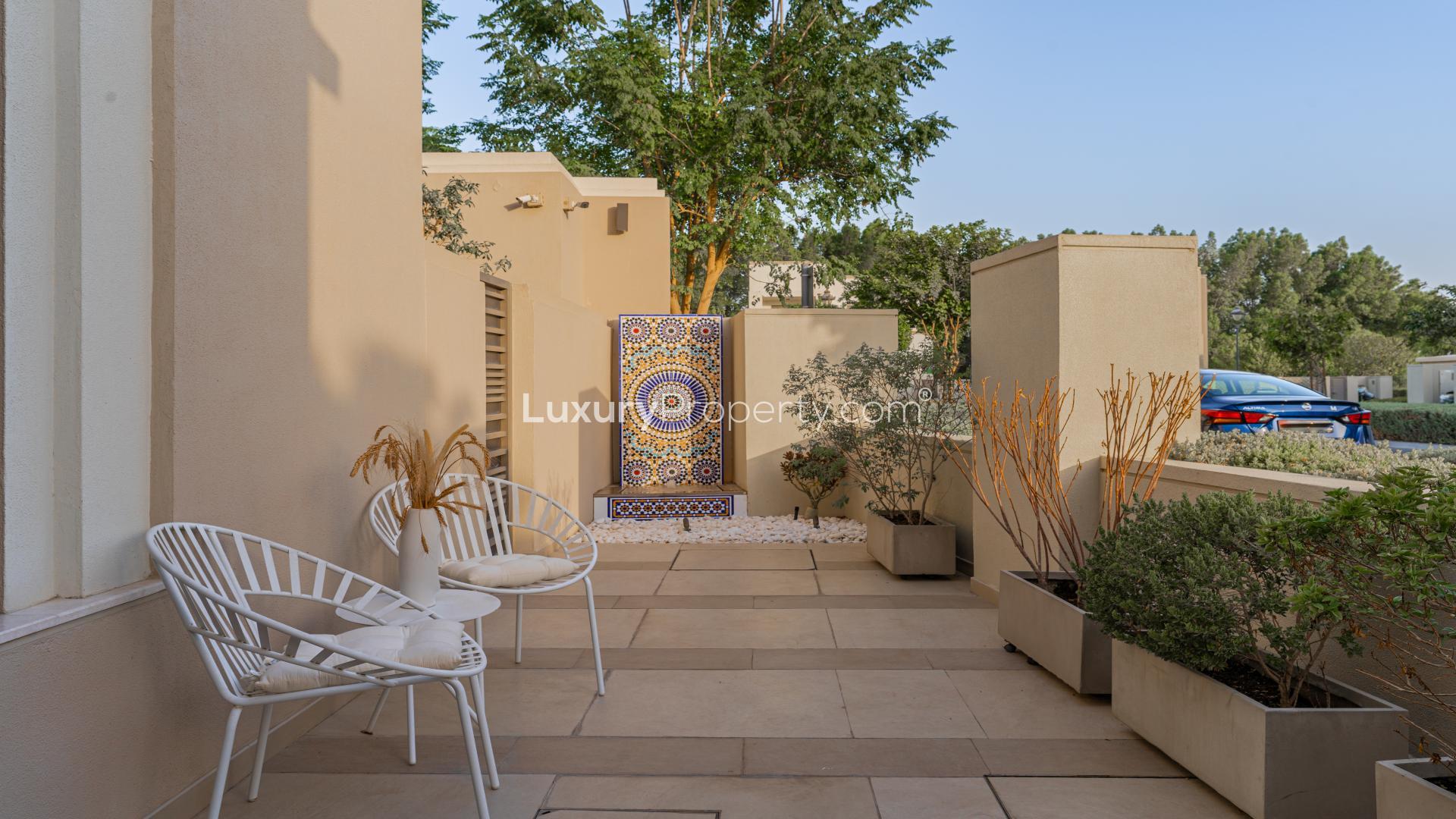 Exterior view of upgraded villa for sale in Azalea, Arabian Ranches 2, featuring lush landscaping