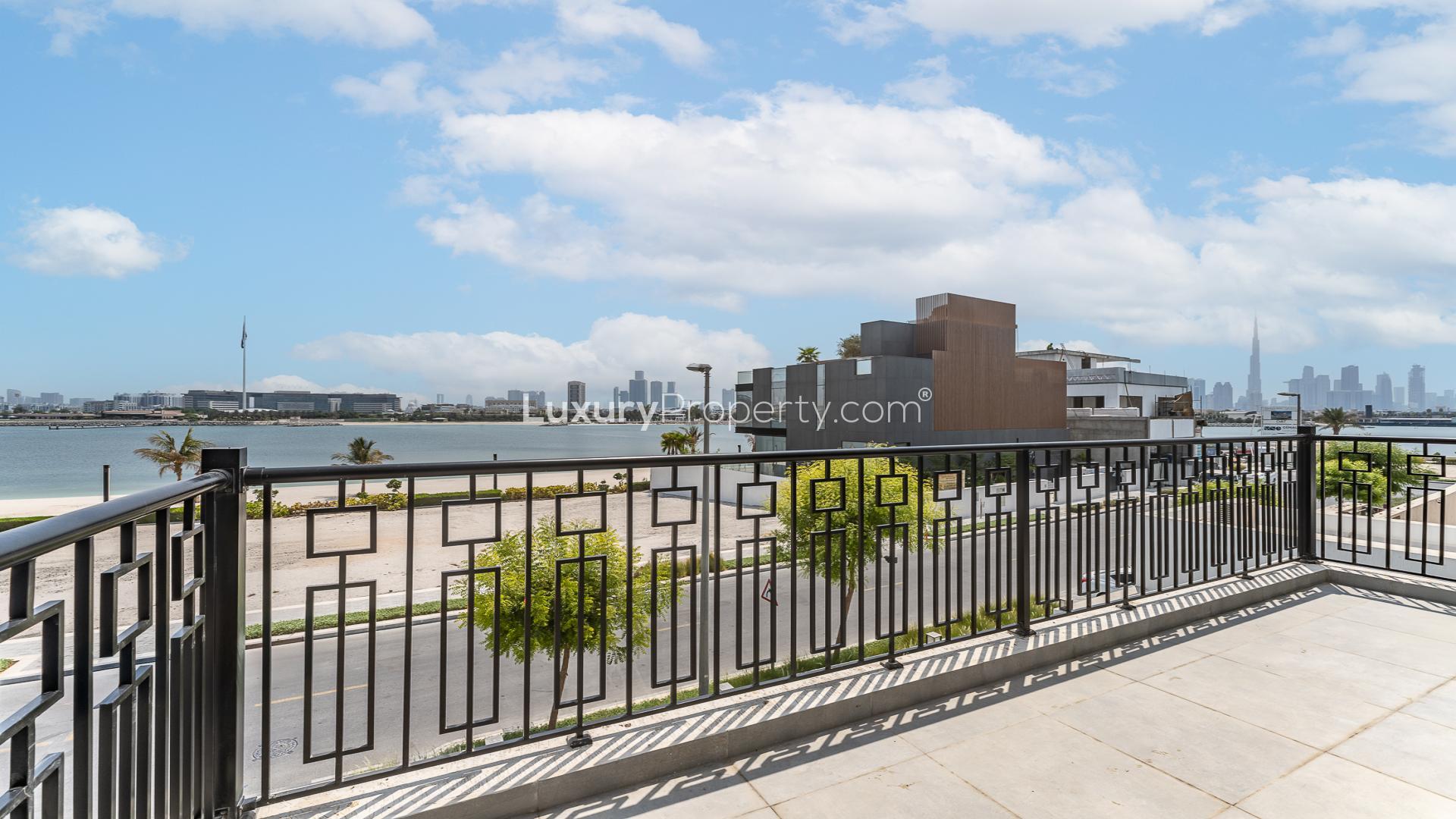 Elegant dining room in luxury Pearl Jumeirah villa with chandelier and marble table