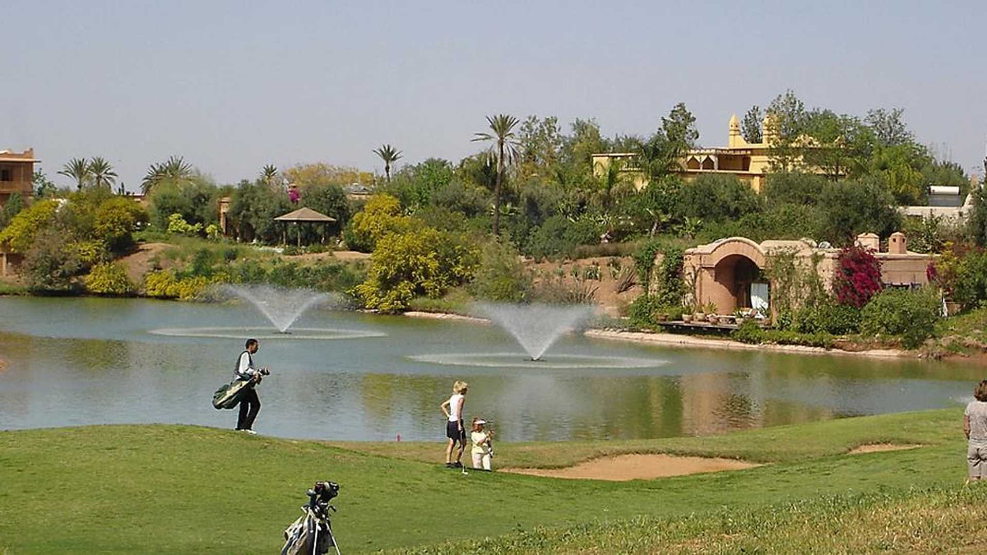 Outdoor patio with wooden dining set at Boccara Hattan villa, Amelkis Resort, Marrakech