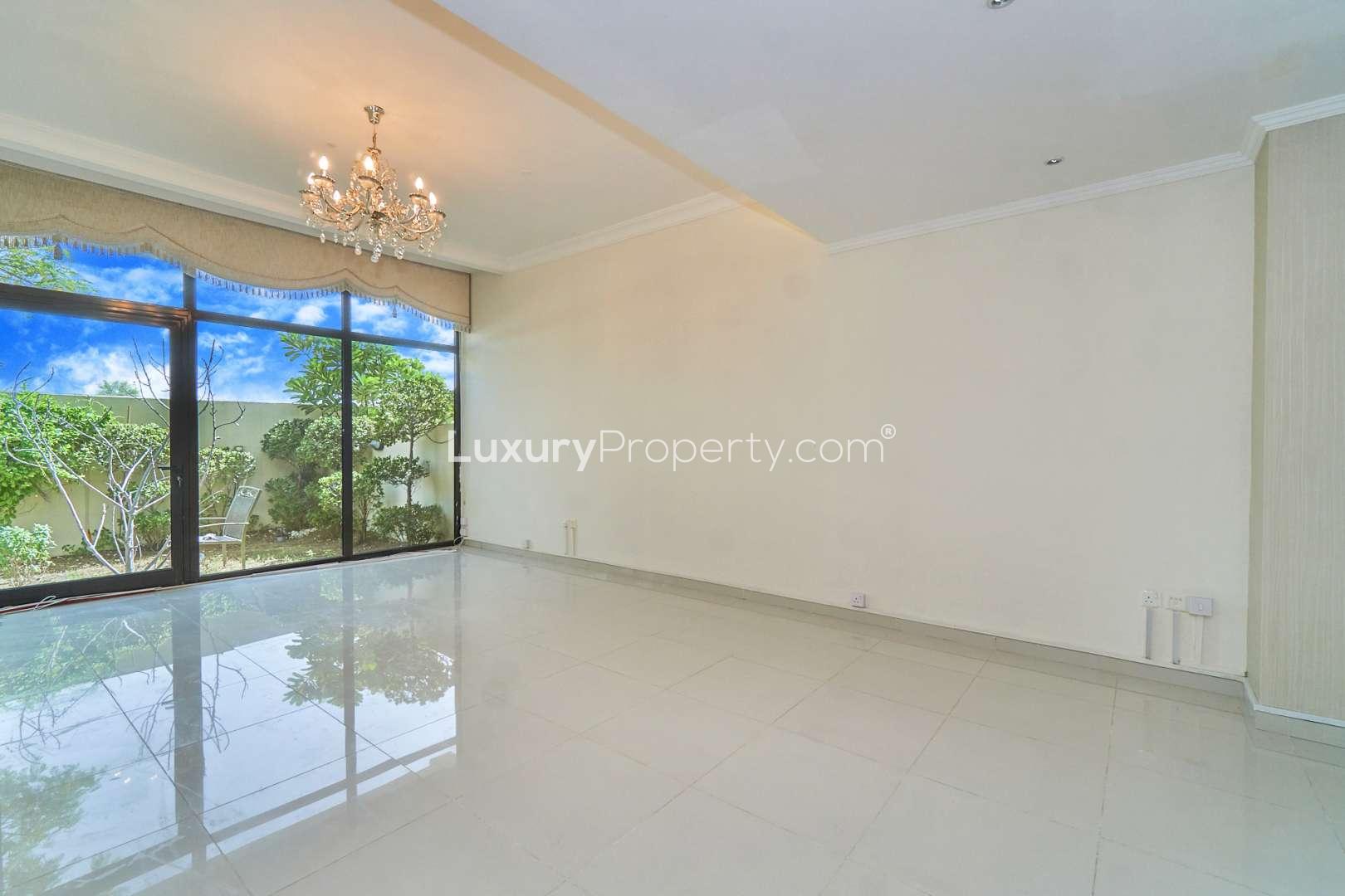 Modern seating area and glass staircase in Damac Hills villa, Brookfield community