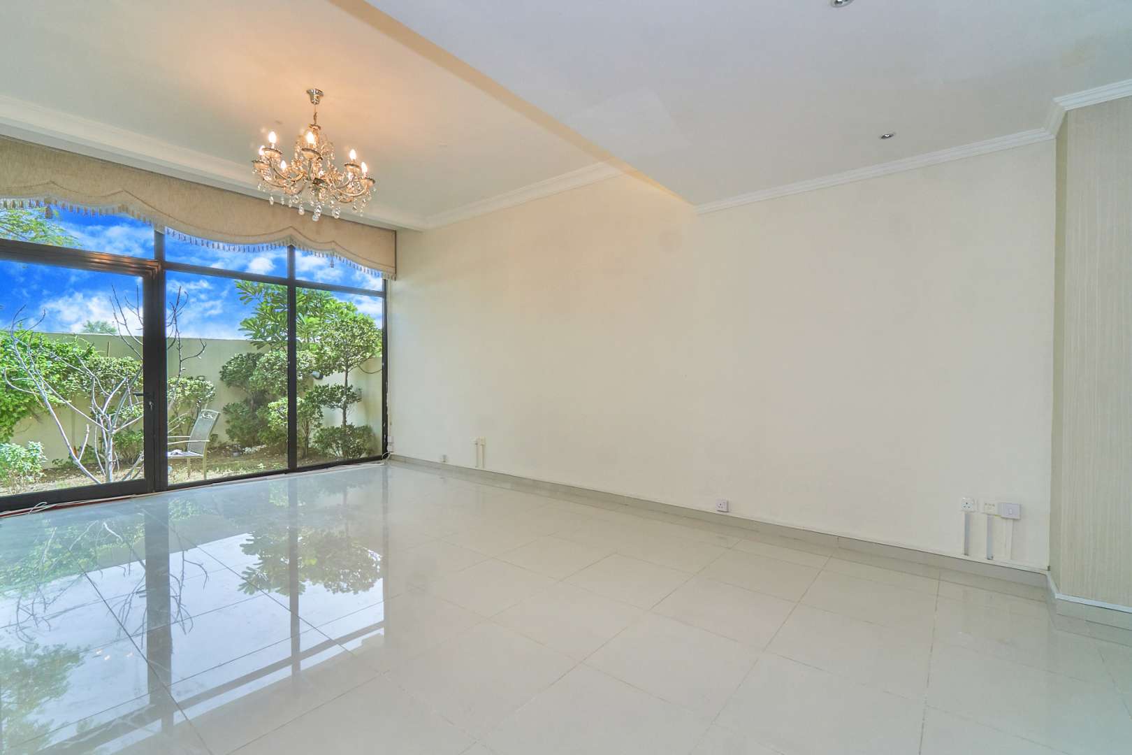 Modern seating area and glass staircase in Damac Hills villa, Brookfield community