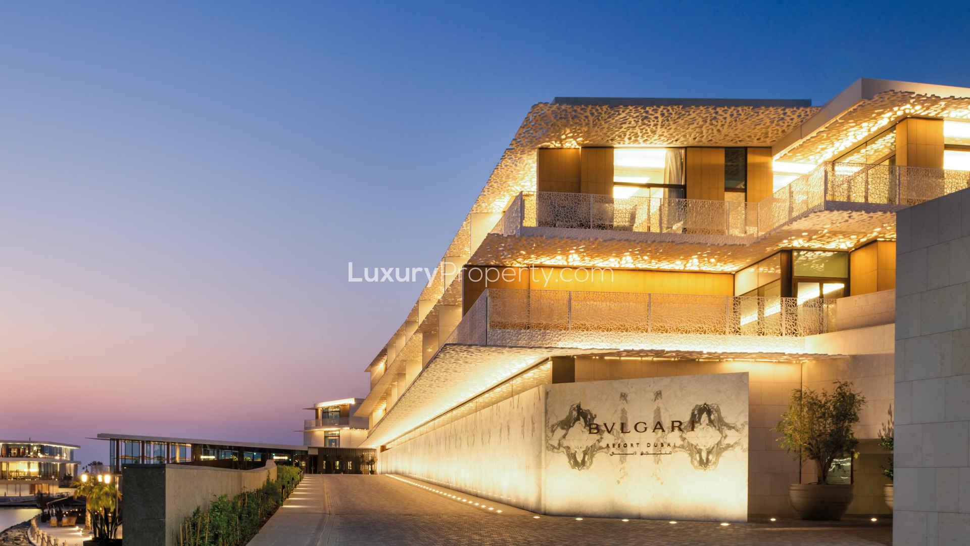Luxurious villa entrance at Bulgari Resort & Residences, Jumeirah Bay Island, with parked cars
