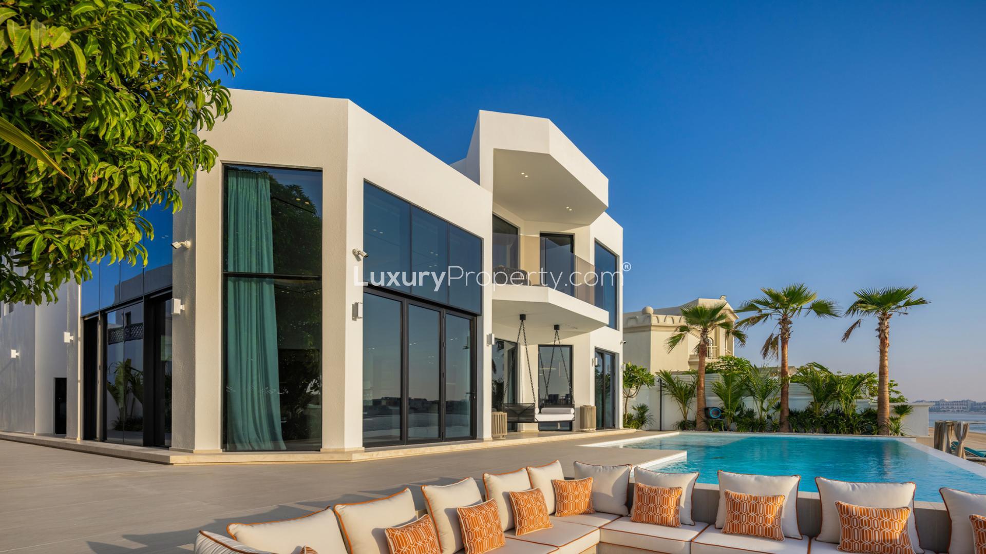 Luxurious Palm Jumeirah villa with pool, modern architecture, and elegant outdoor seating area
