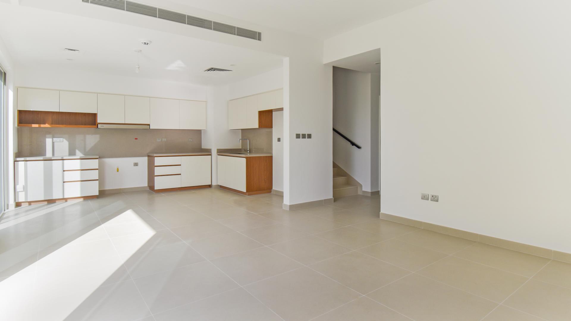 Bright open-plan kitchen and living area in Camelia villa, Arabian Ranches 2