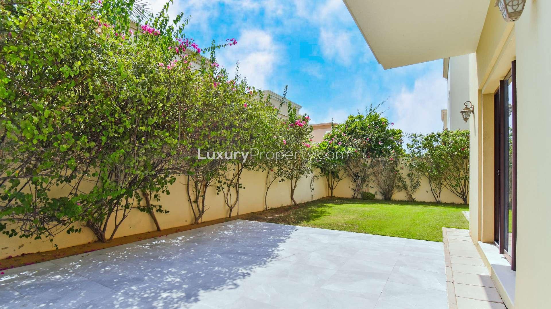 "Private garden view of 4-bedroom villa for sale in Casa, Arabian Ranches 2.",Modern kitchen with wooden cabinets in 4-bedroom villa, Casa, Arabian Ranches 2