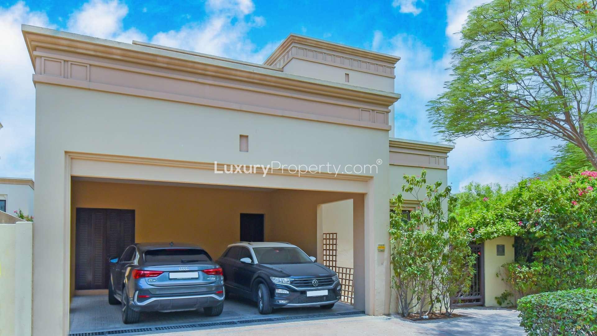 Lush garden view of Casa villa in Arabian Ranches 2, featuring vibrant greenery and flowers