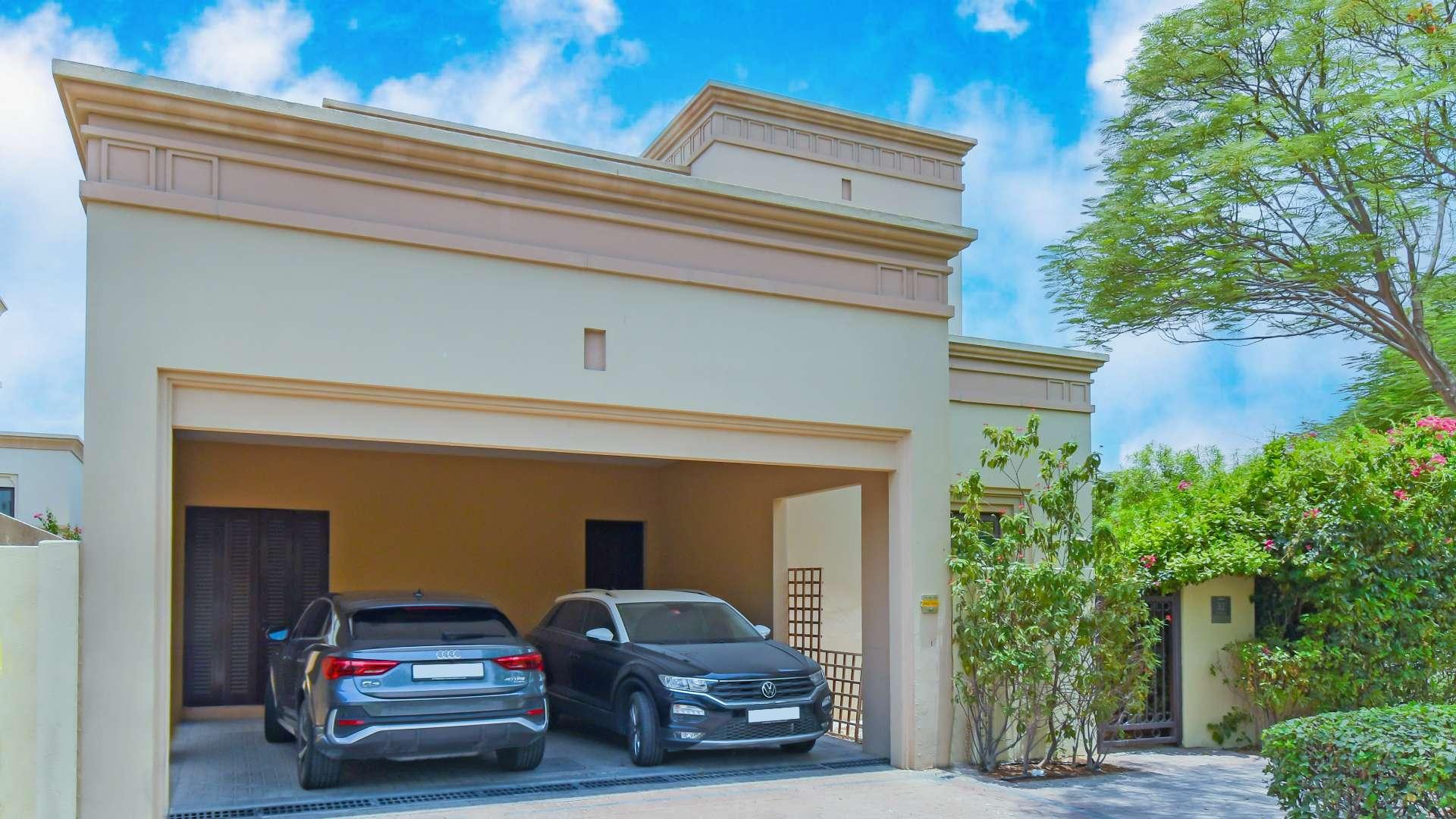 Lush garden view of Casa villa in Arabian Ranches 2, featuring vibrant greenery and flowers