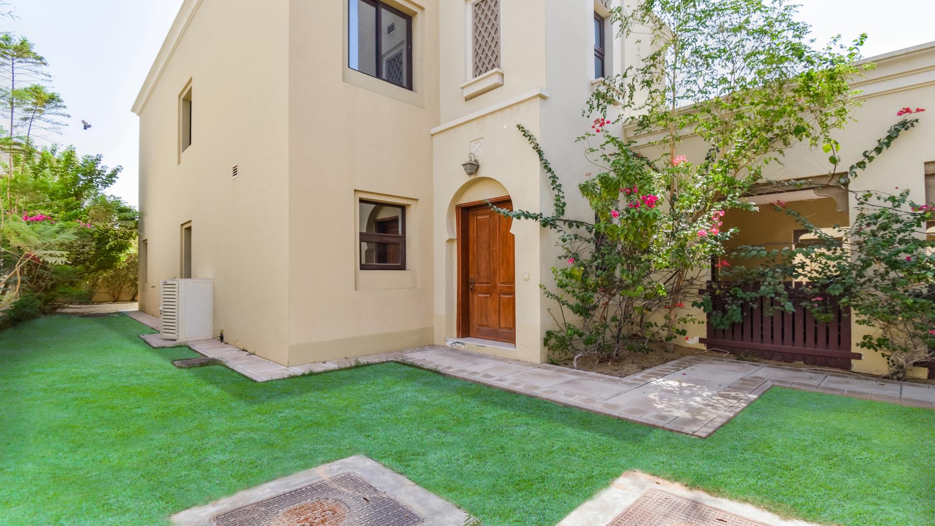 "Charming villa entrance with lush garden in Casa, Arabian Ranches 2, for sale.",Spacious living room with staircase in 4-bedroom villa, Arabian Ranches 2, Casa community