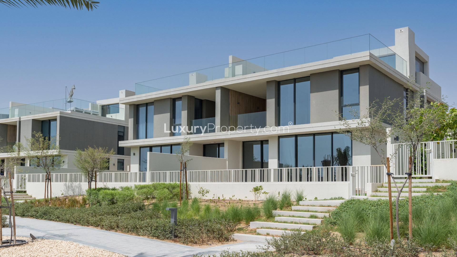 Modern villa exterior in Club Villas, Dubai Hills Estate, featuring sleek design and landscaping