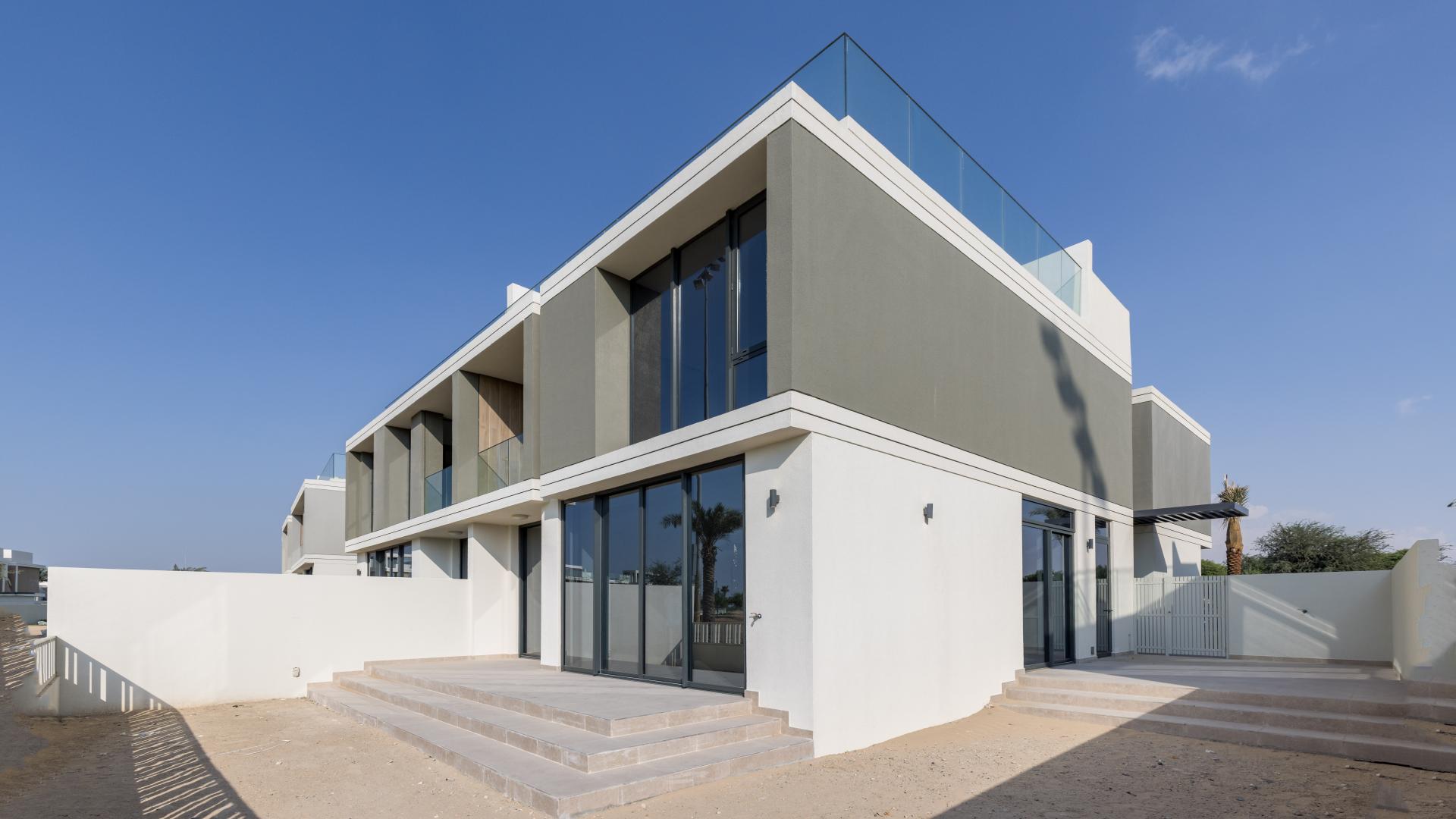 Open-plan kitchen and living area in Dubai Hills Estate villa with golf course views