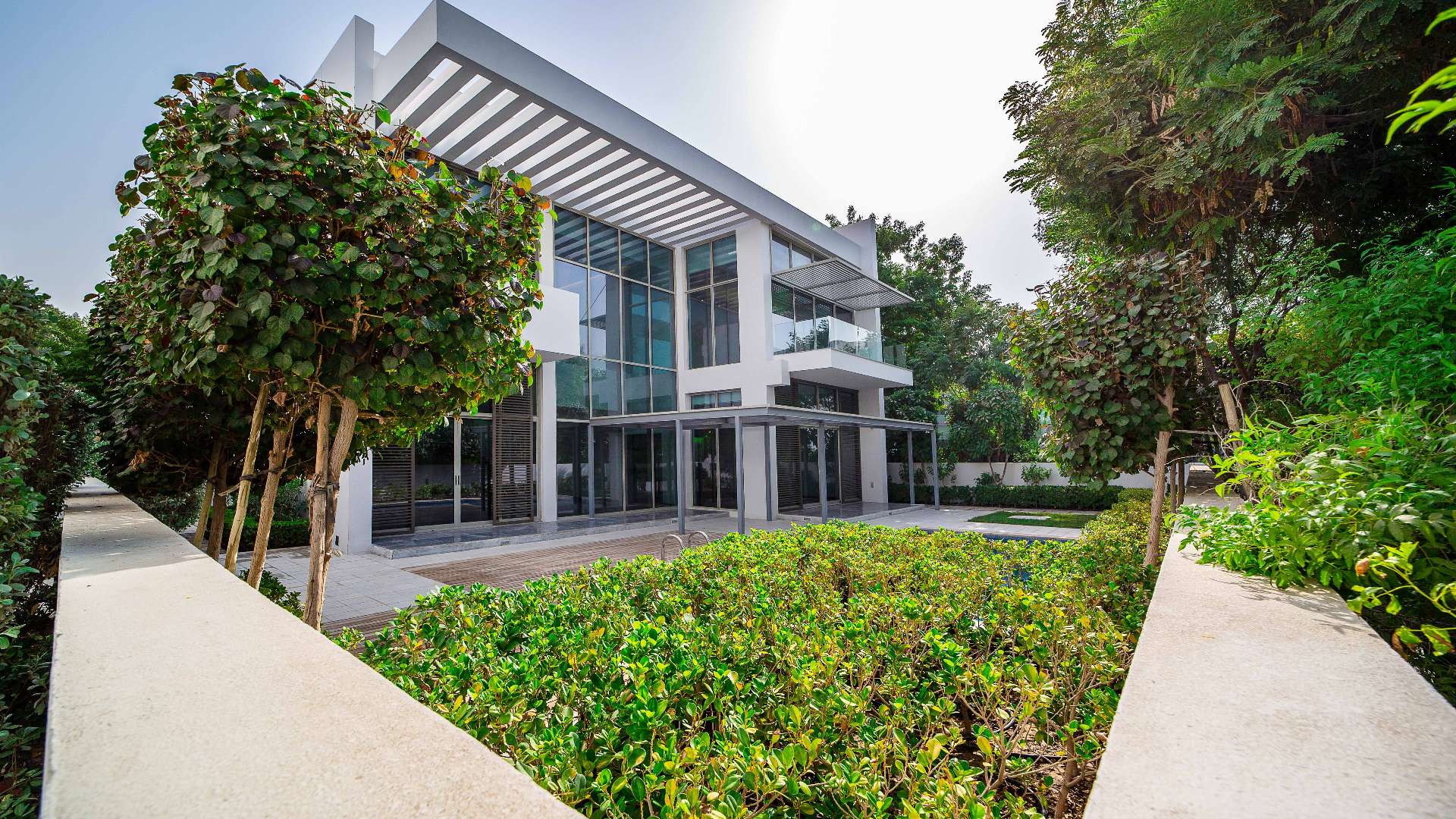 Luxurious living room in 4-bedroom villa, District One, Dubai, with modern decor and garden view