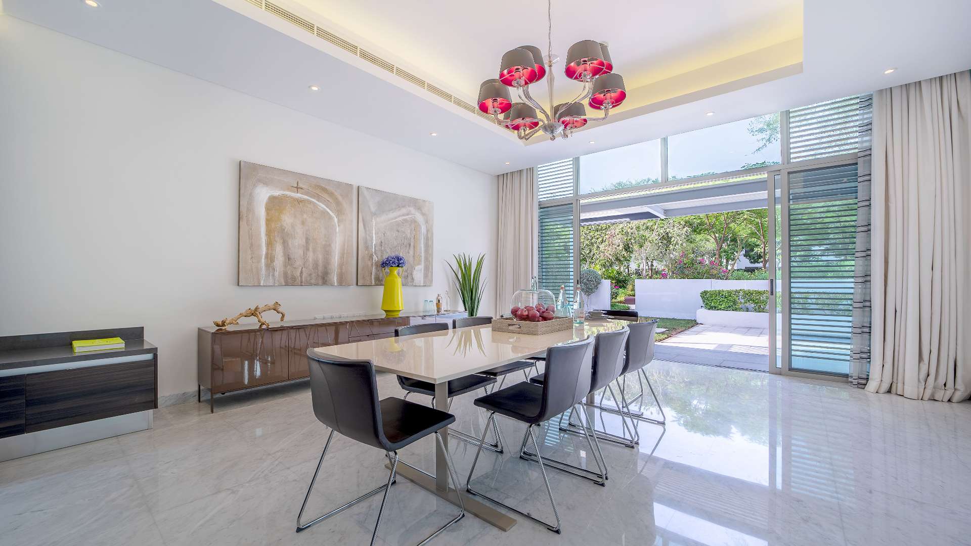 Contemporary dining room in District One villa, featuring modern decor and garden view