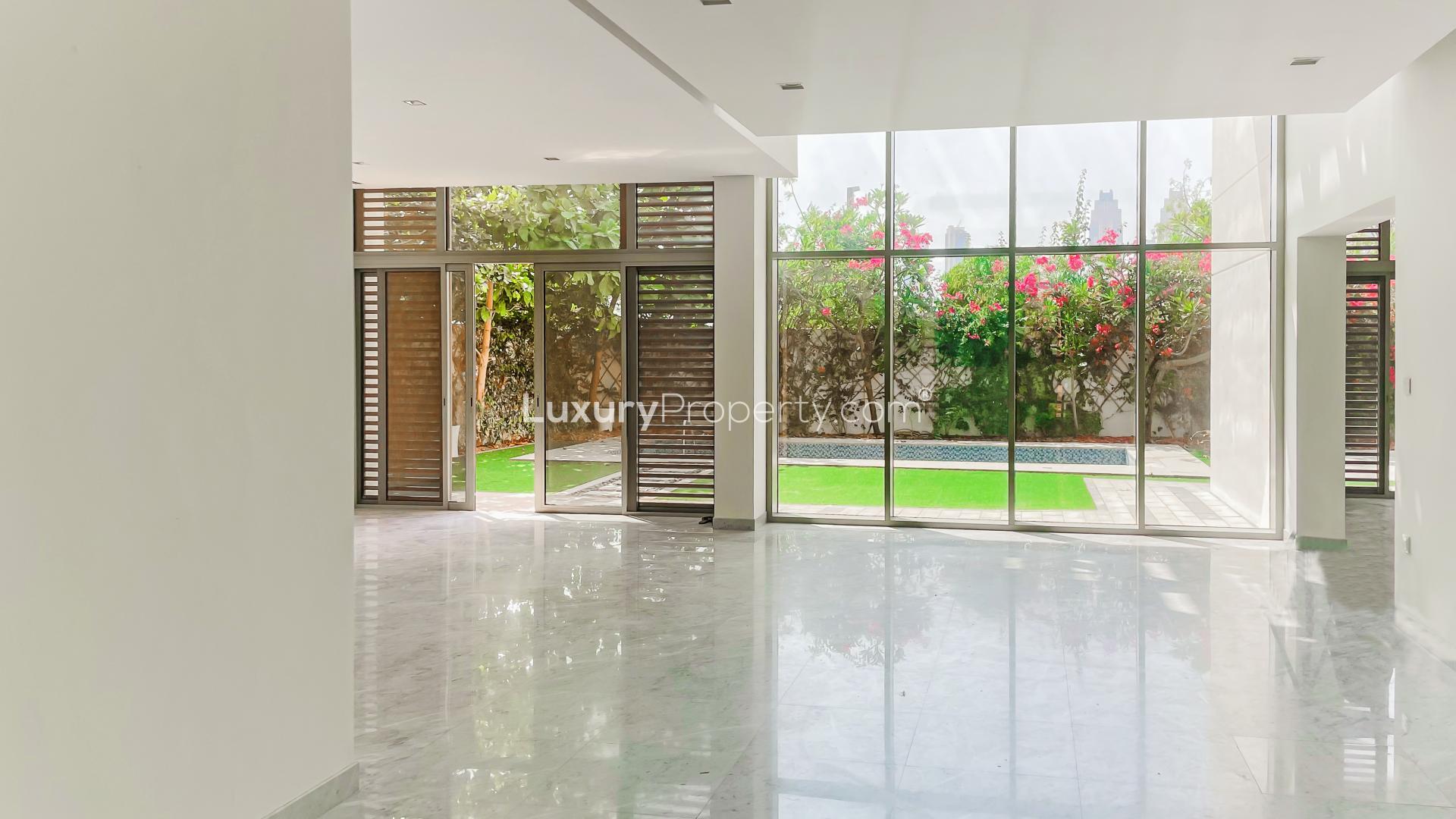 Outdoor pool with lush garden at contemporary villa in District One, Mohammed Bin Rashid City