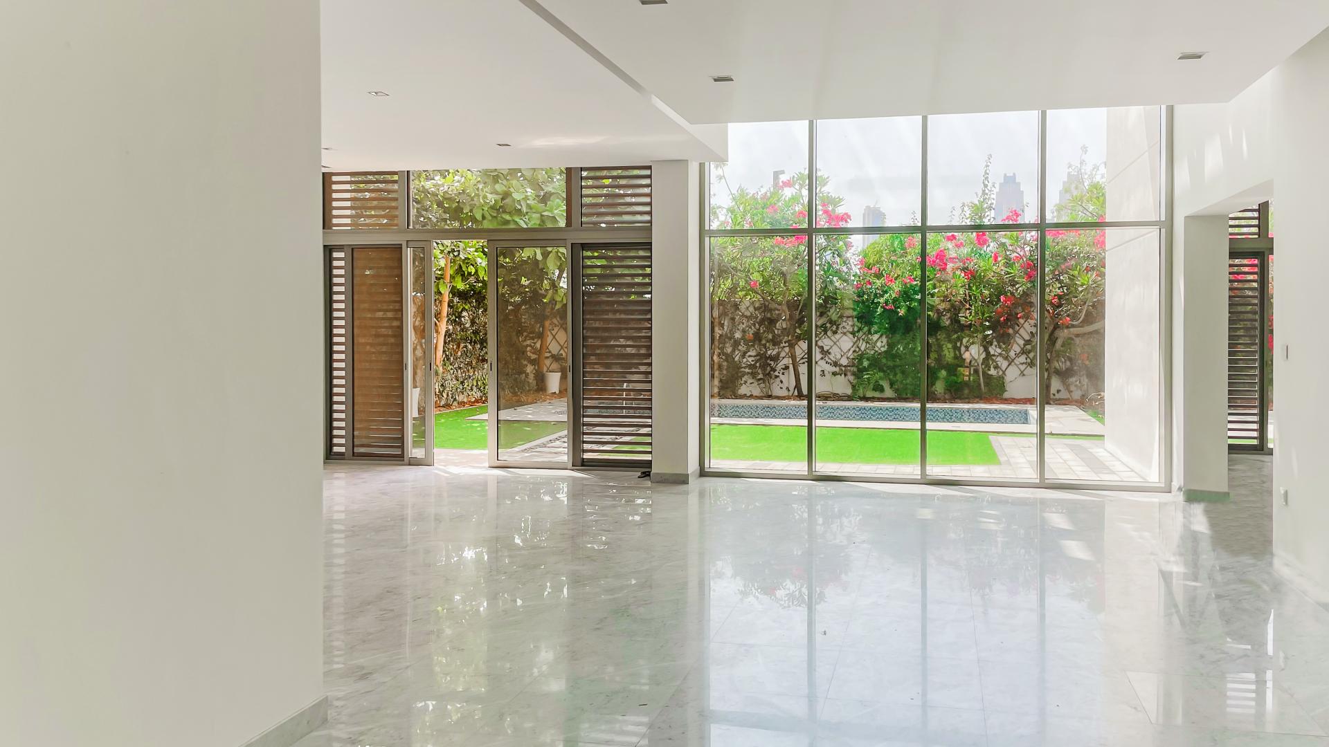 Outdoor pool with lush garden at contemporary villa in District One, Mohammed Bin Rashid City