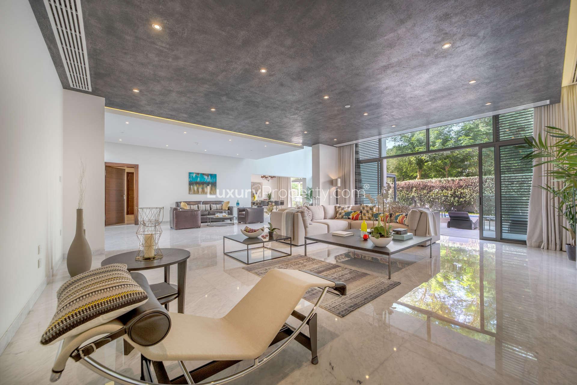 Contemporary dining room in a luxury villa, District One, with garden view
