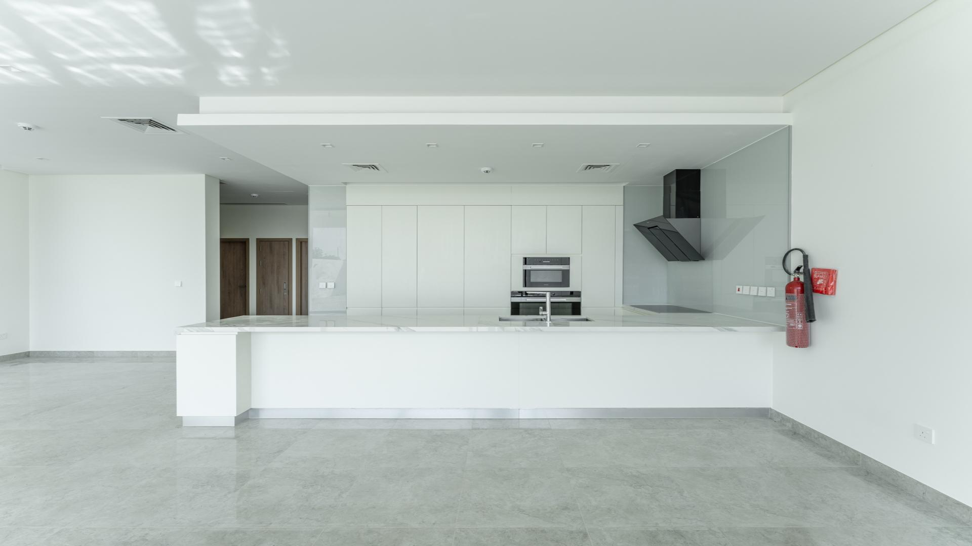 Modern kitchen with large windows and garden view in District One villa, Mohammed Bin Rashid City