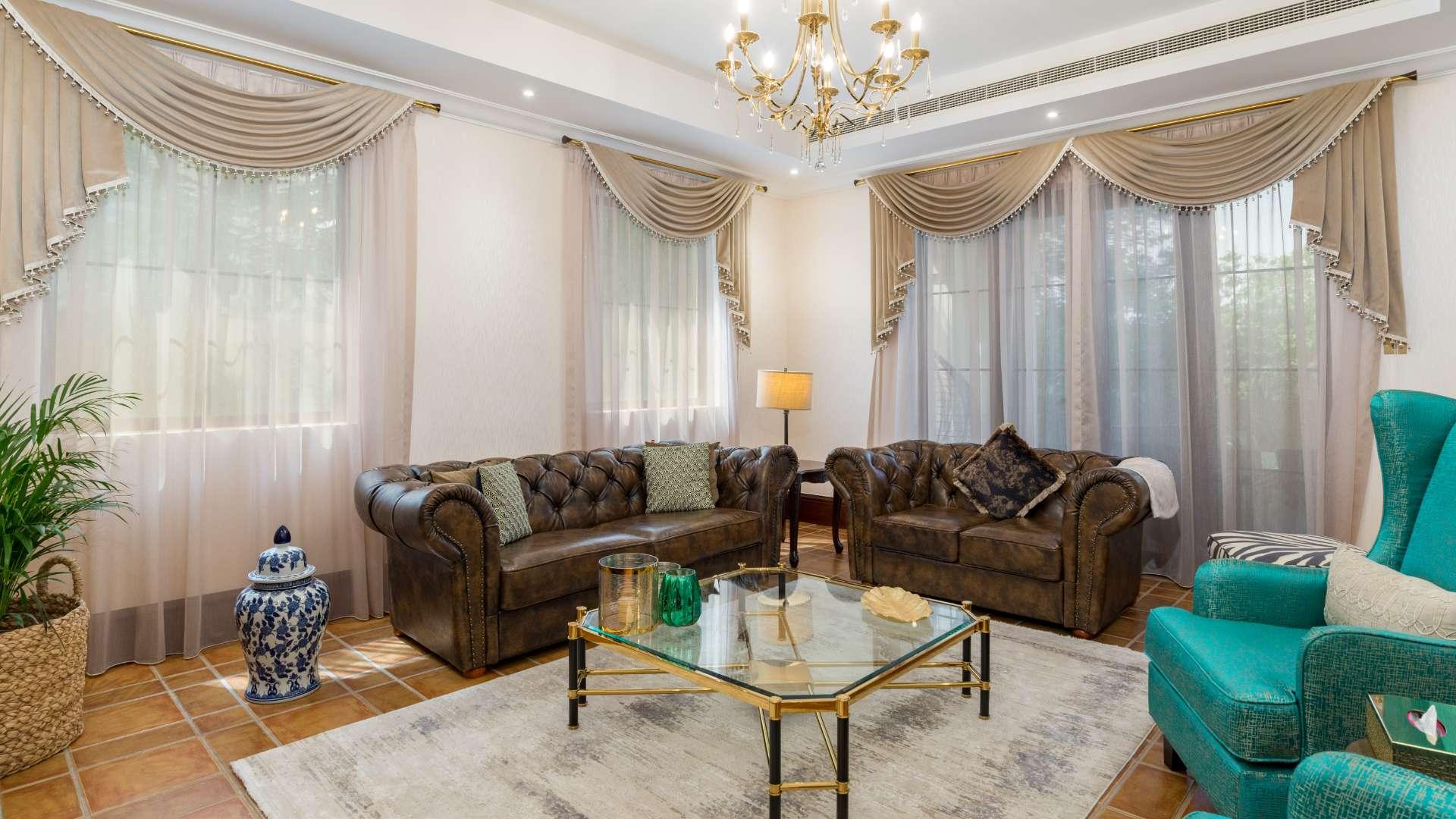 Elegant living room in upgraded four-bedroom villa, Jumeirah Golf Estates, featuring luxurious decor