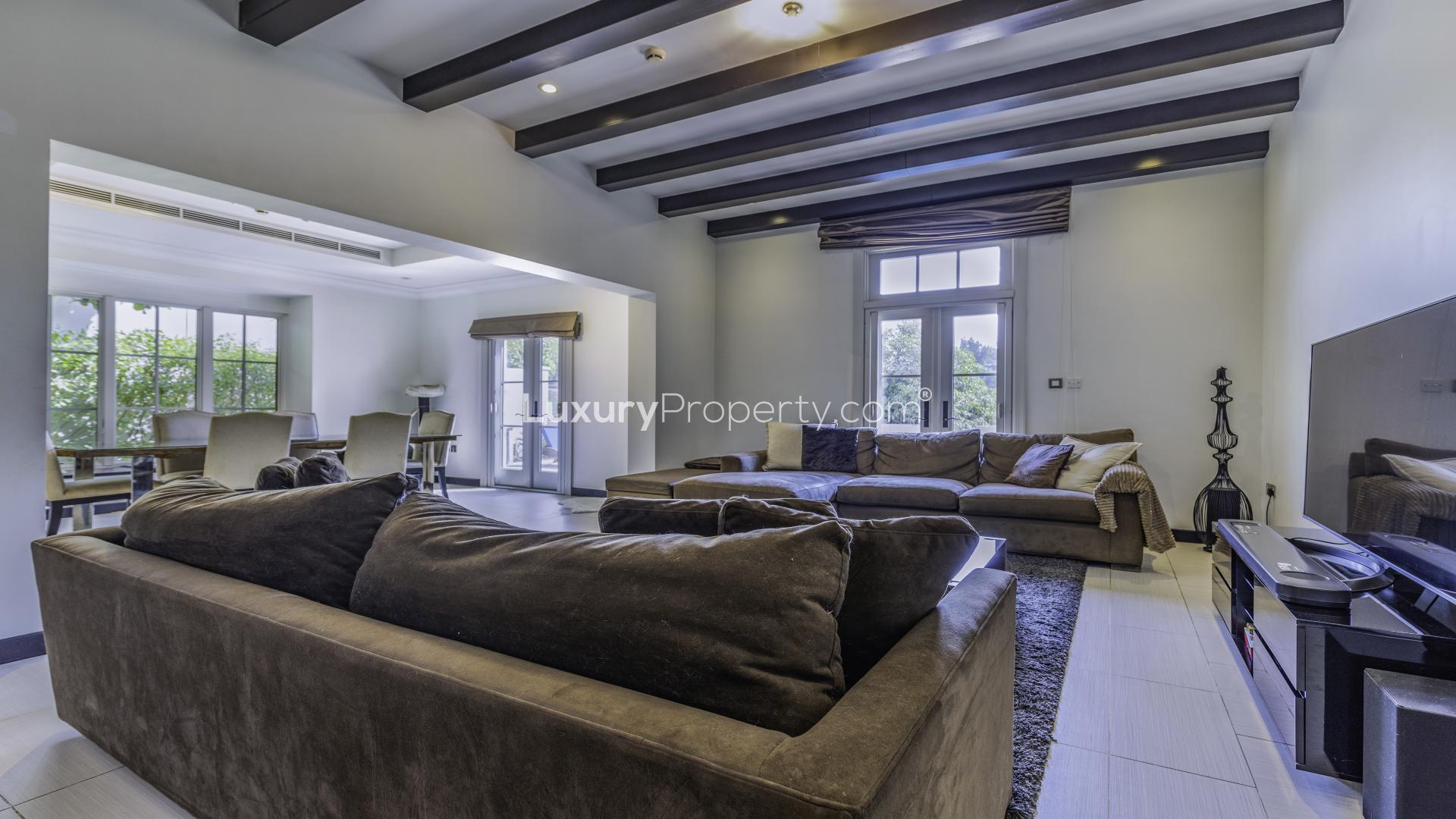 Luxurious living room in Doral Type villa, Jumeirah Golf Estates, with modern decor and TV